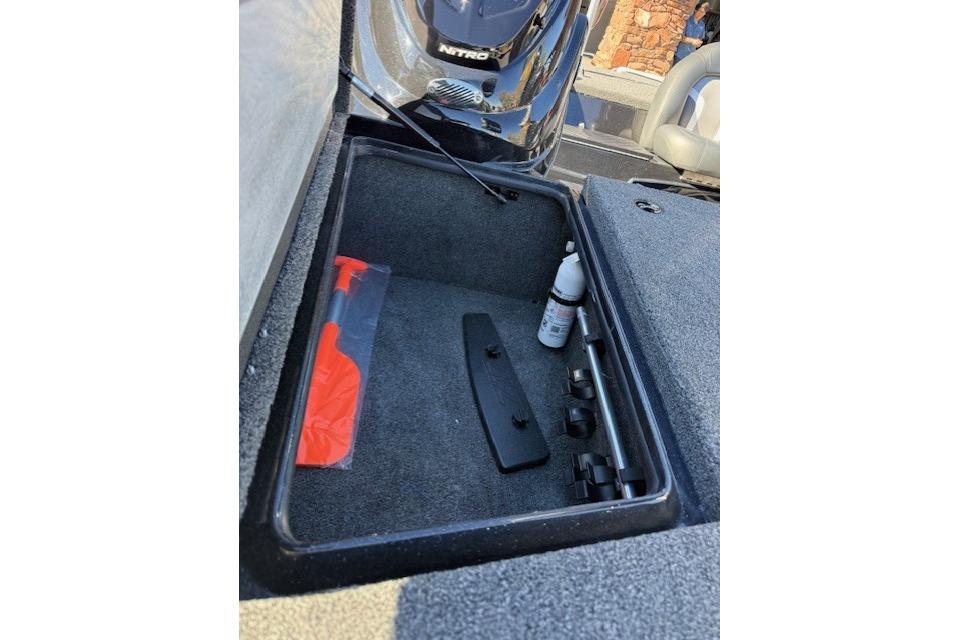 Open storage compartment in 2026 Nitro Z17 boat with tools and accessories.