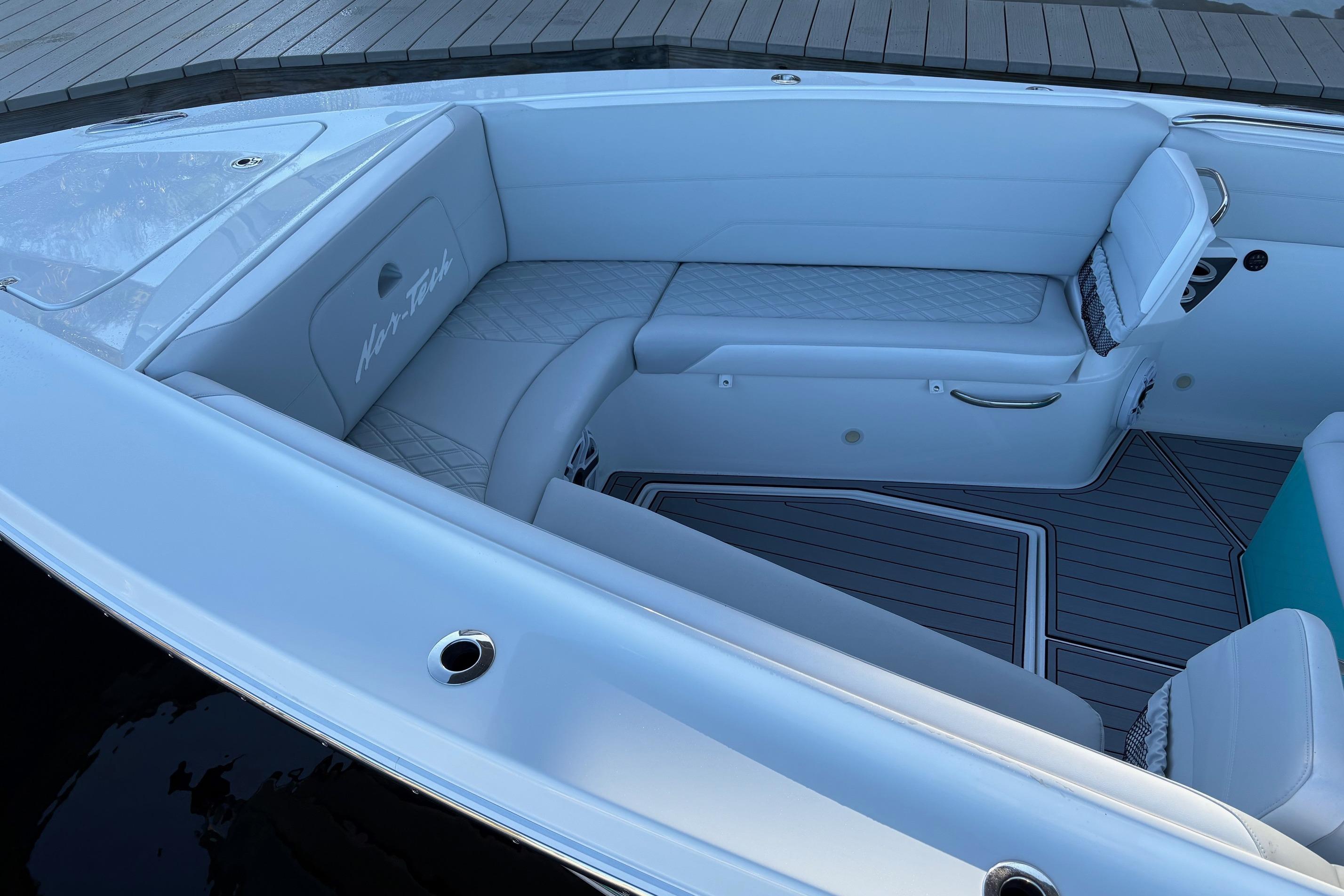 2024 Nor-Tech 390 Sport Center Console boat interior with white seating and sleek design.