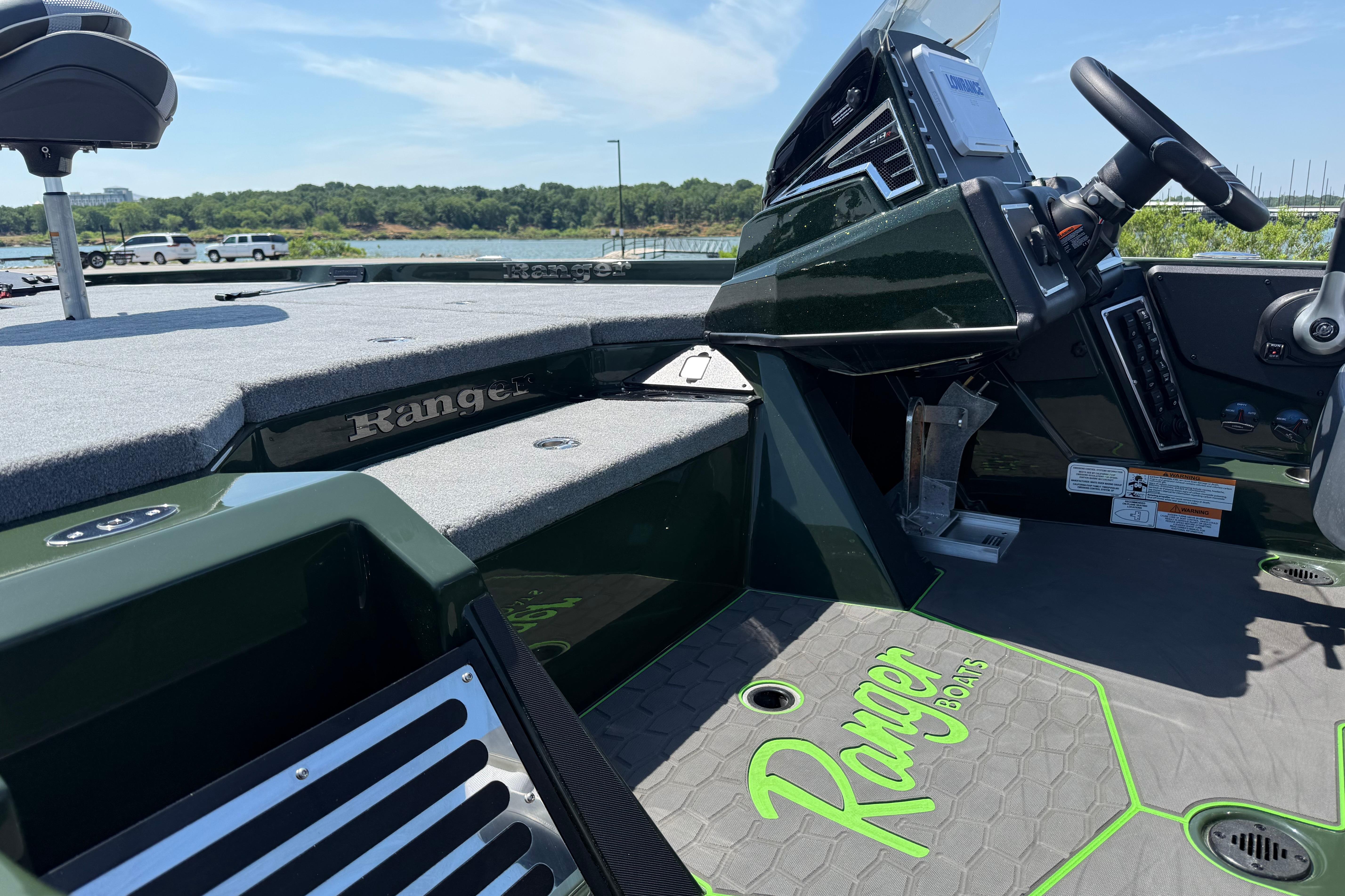 2026 Ranger Z519R boat interior with steering console and seating, docked by a scenic lake.