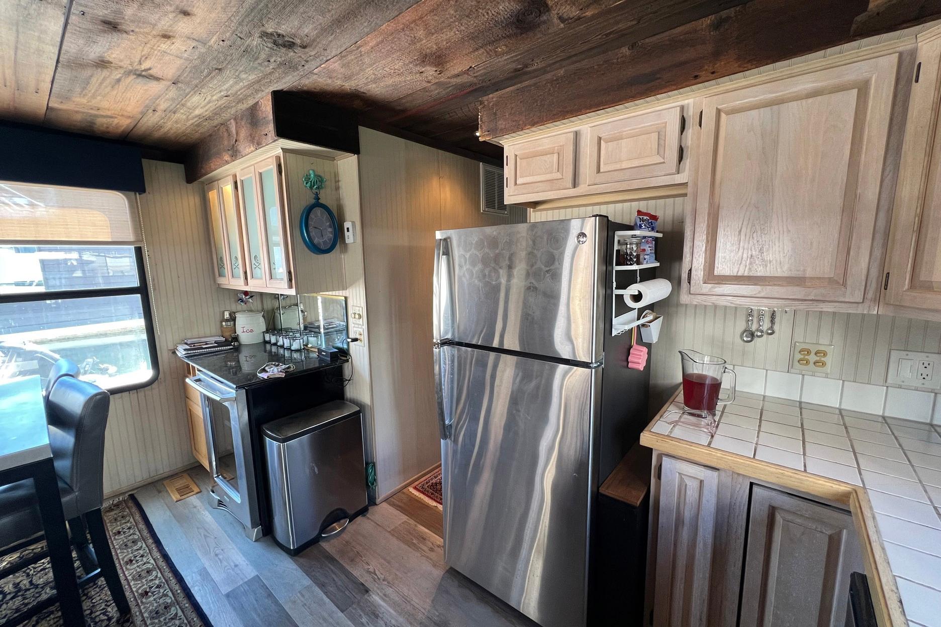 1993 Sumerset houseboat kitchen with stainless steel appliances and wooden cabinetry.