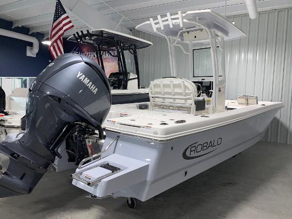 2024 Robalo 246 Cayman boat with Yamaha outboard motor in showroom.