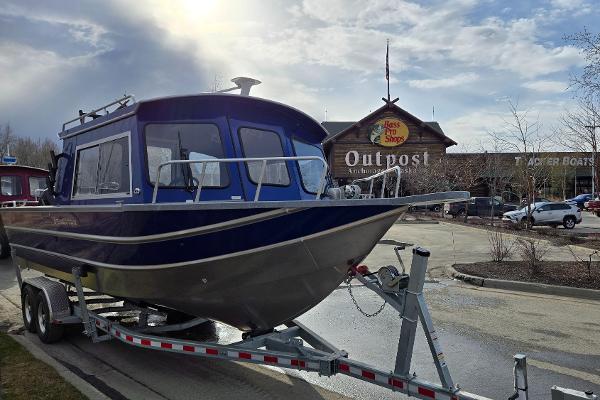 2024 Spartan 26 Maximus Pro XL boat on trailer outside Bass Pro Shops Outpost.