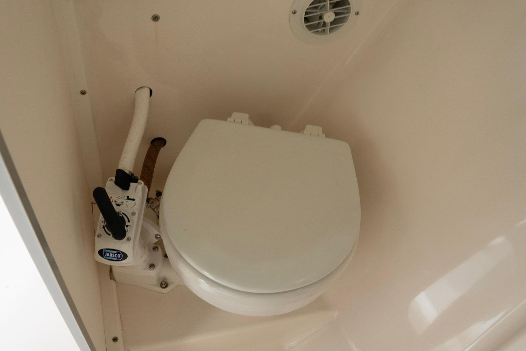2006 Atlas Boat Works Acadia 25 marine toilet with Jabsco pump in compact bathroom.