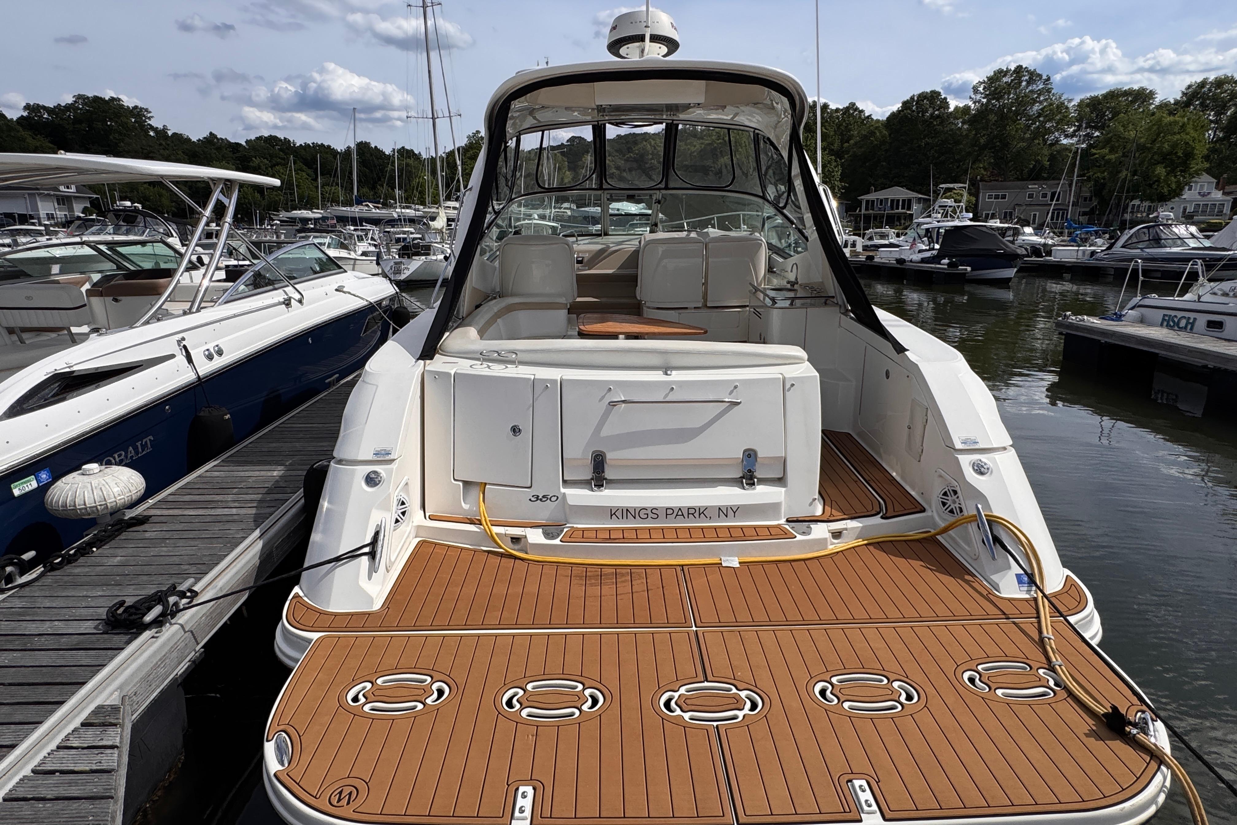 2008 Sea Ray Sundancer 350 docked at marina, featuring spacious deck and elegant design.
