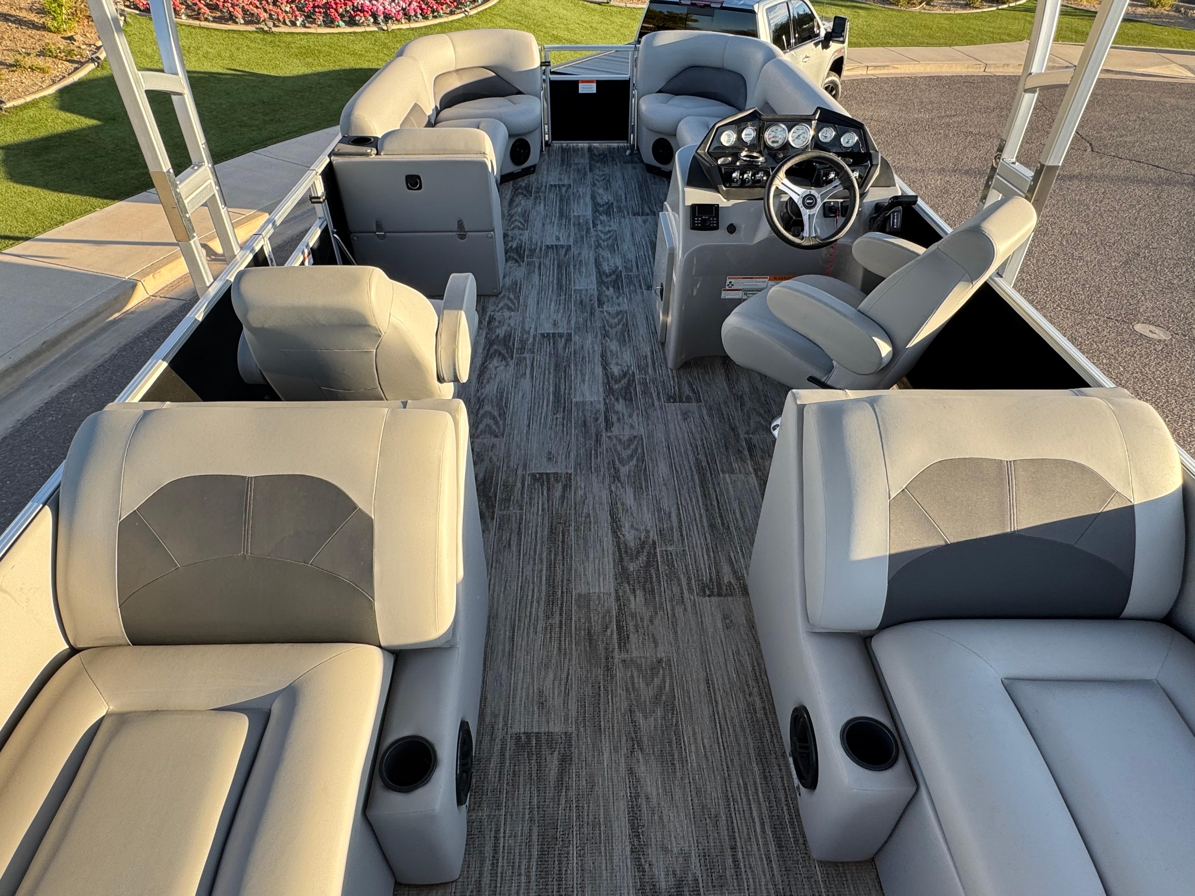 2024 Landau Island Breeze 252 pontoon boat interior with gray seating and modern dashboard.