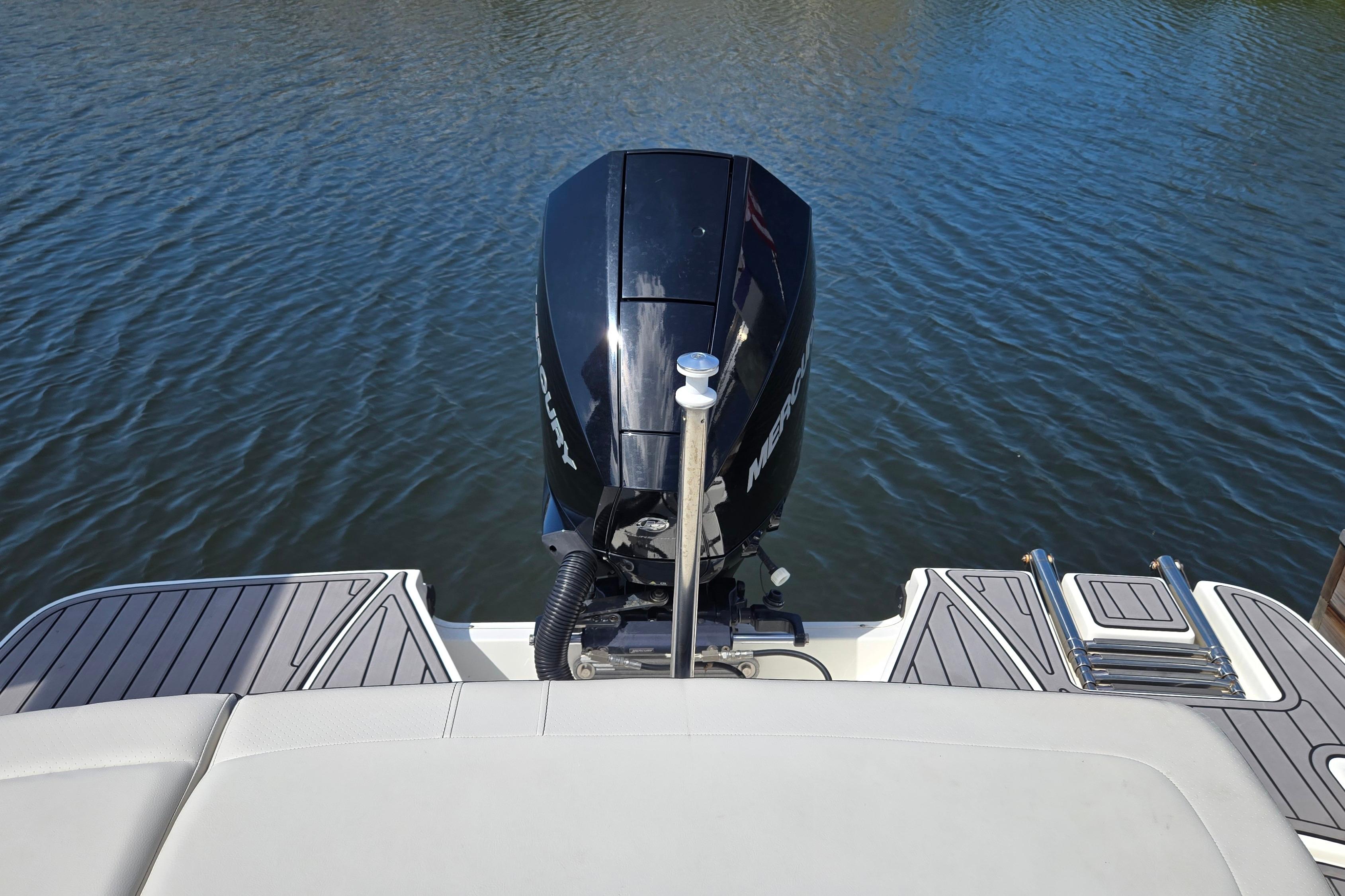 2023 Sea Ray SPX 210 boat with Mercury outboard motor on calm water.