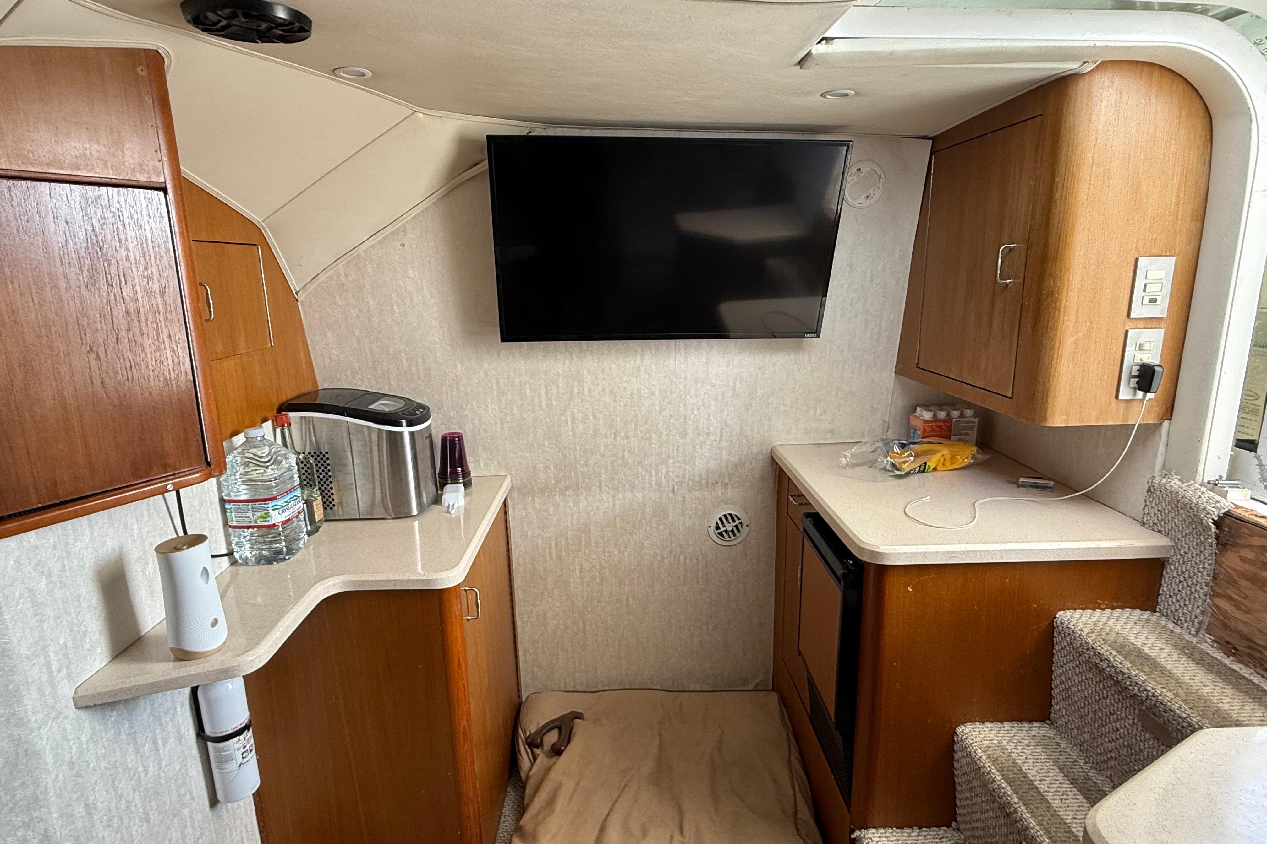 Interior of 1999 Ocean Yachts 40 Express with kitchenette and mounted TV.