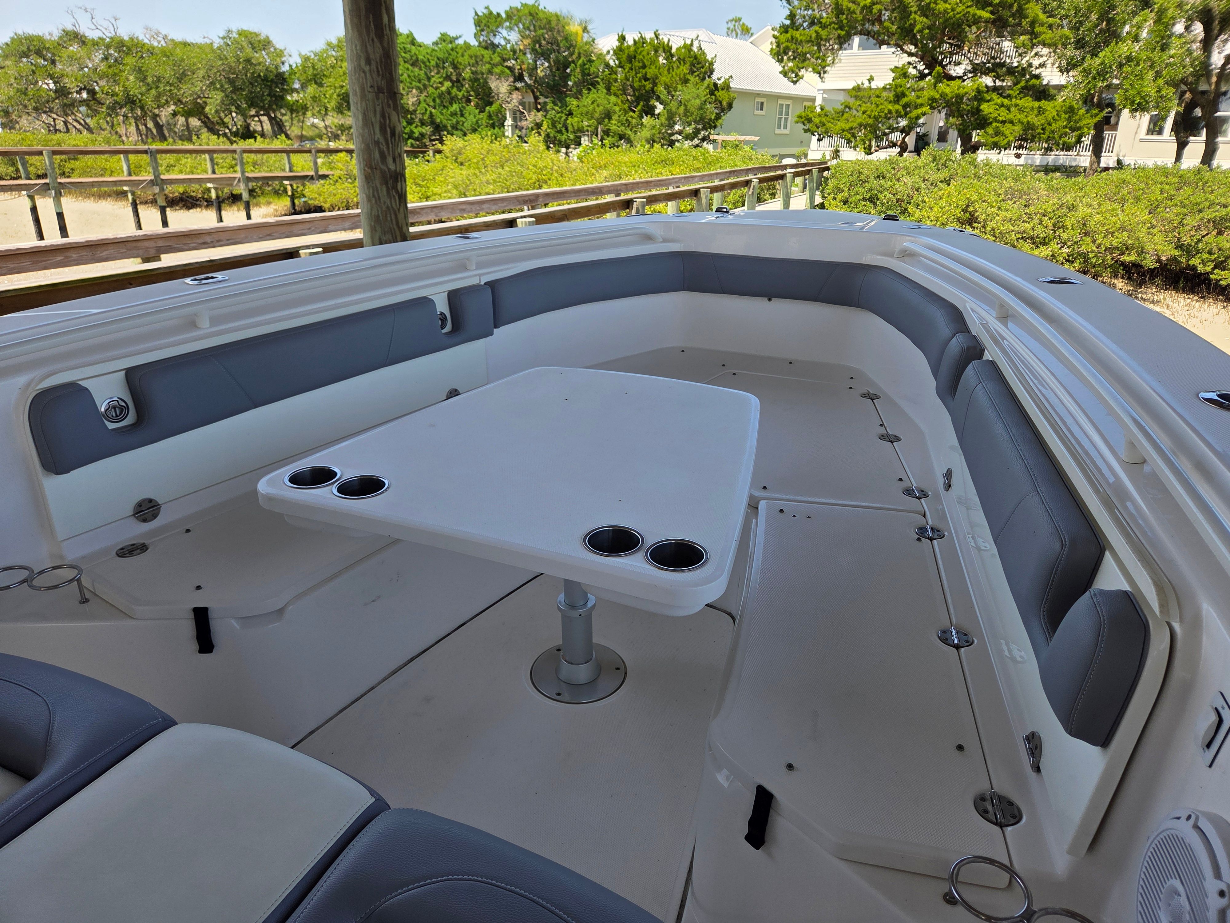 The image shows the cockpit of a 2017 Everglades 355 Center Console boat with a table.