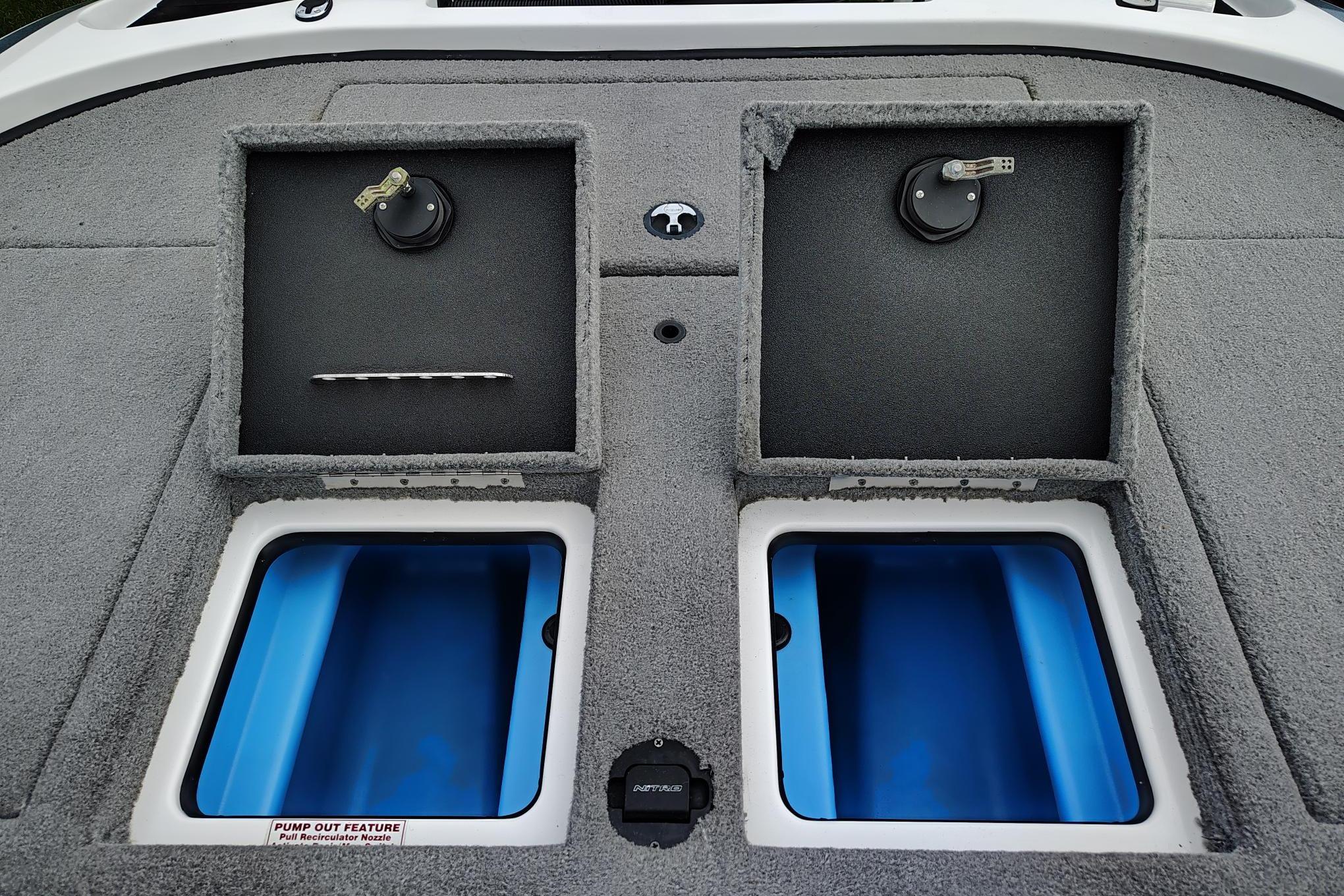 2024 Nitro Z20 boat storage compartments with blue interiors and pump-out feature.