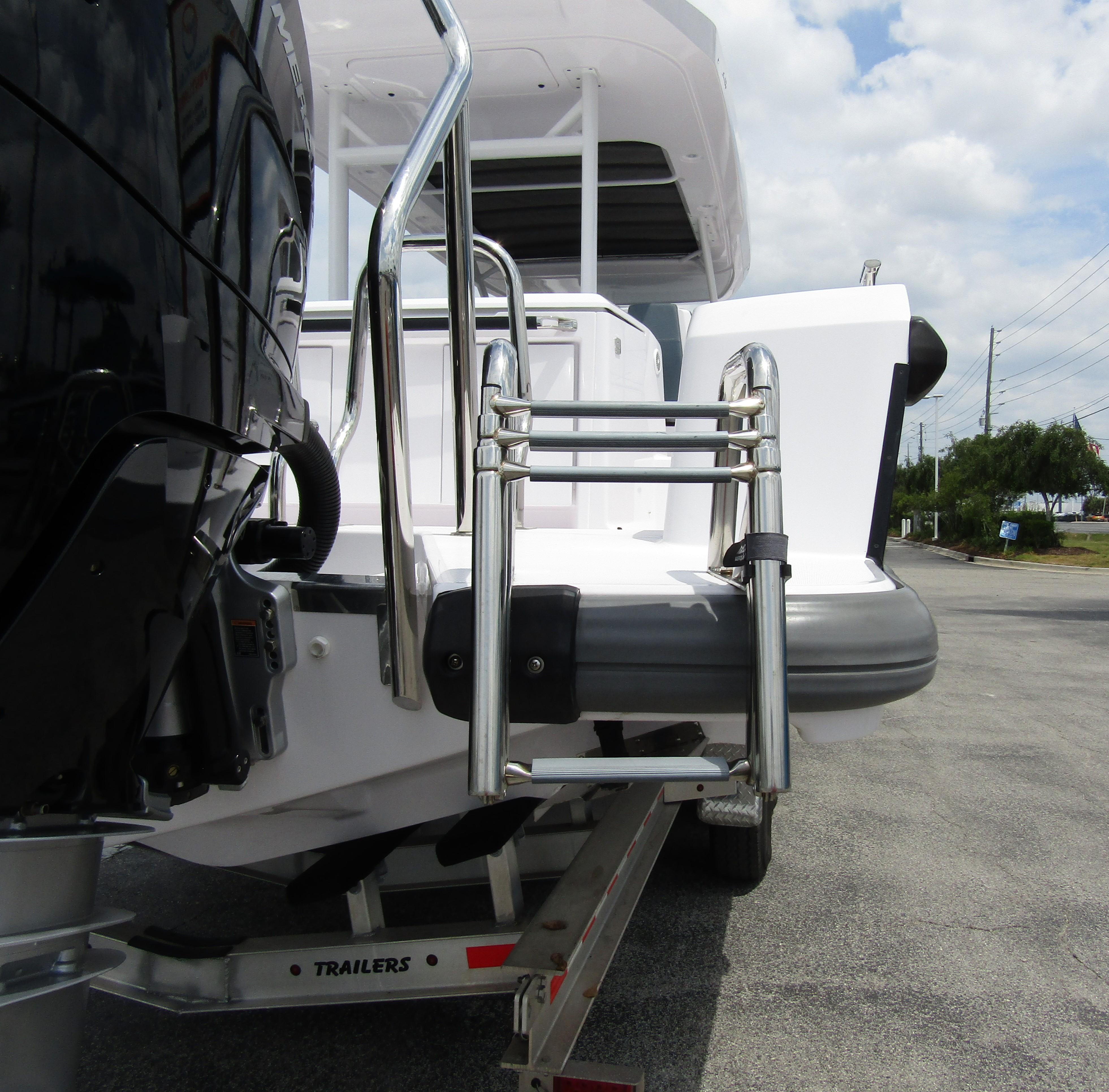 2024 Axopar 37 Sun Top boat with stainless steel ladder and outboard motor.