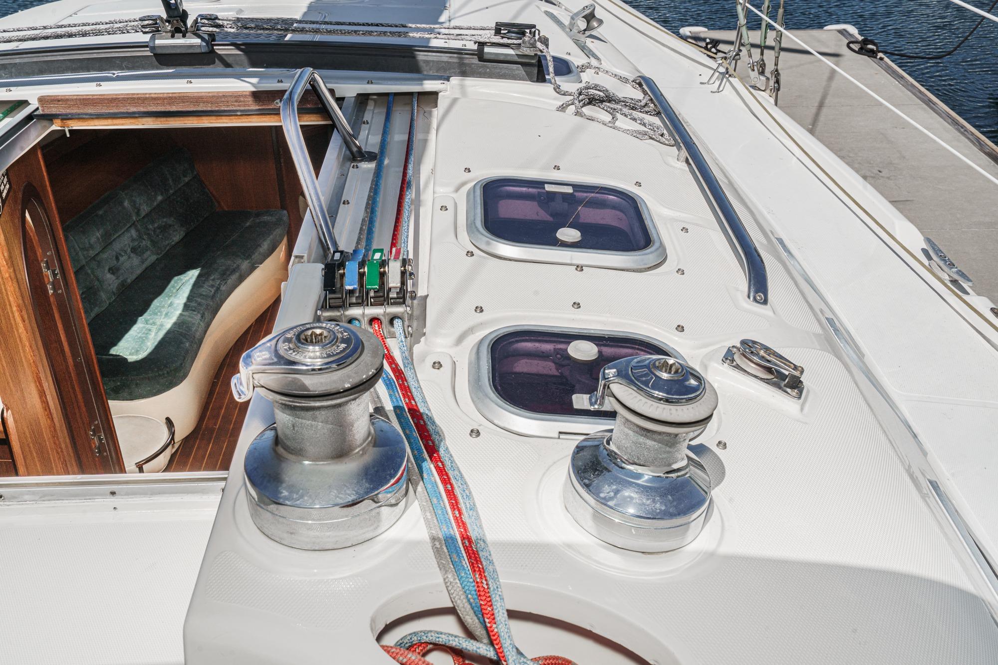 Deck view of a 1996 Hunter 376 sailboat, featuring winches and cabin entrance.