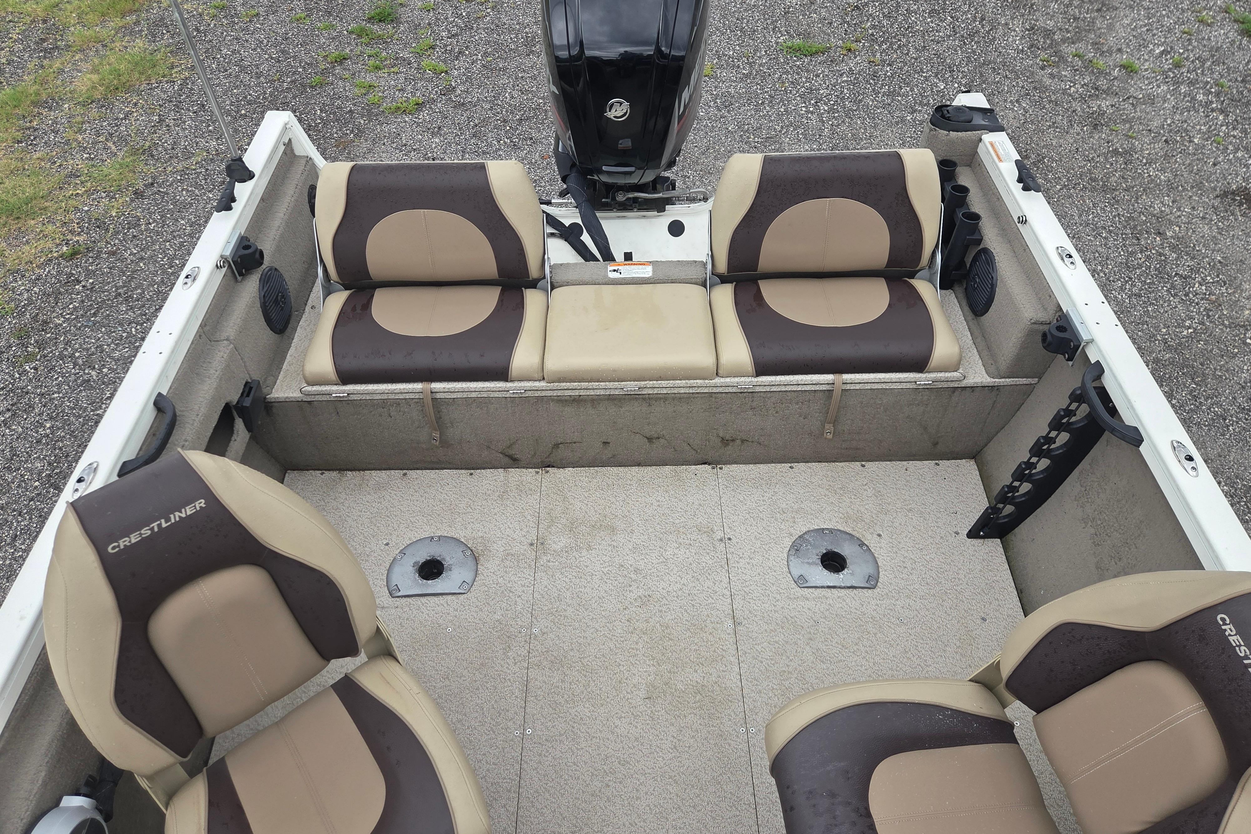 2016 Crestliner 1650 Fish Hawk SC interior with beige and brown seating, motor visible.