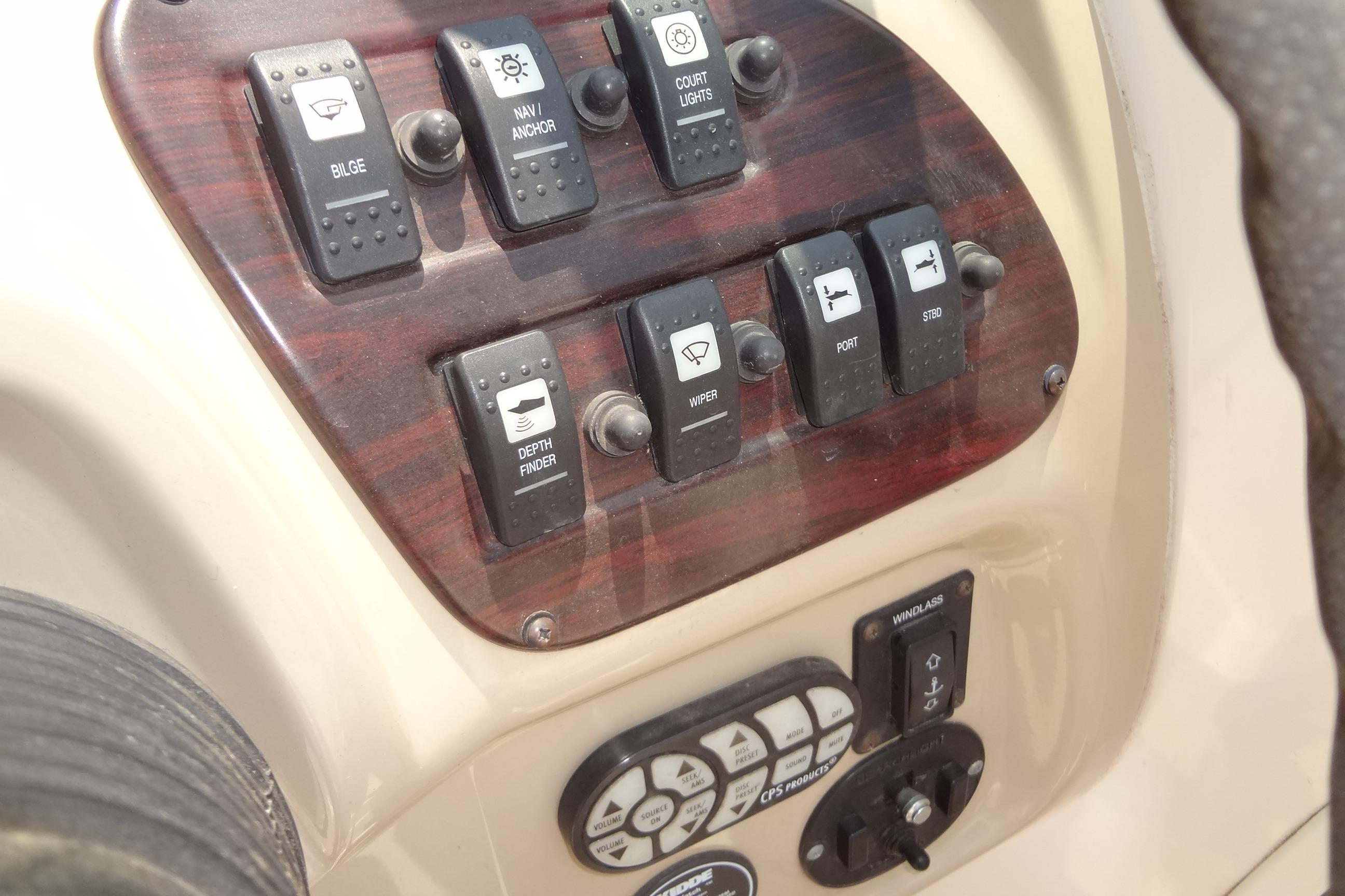 Control panel of a 2000 Chaparral Signature 260 boat with various switches.