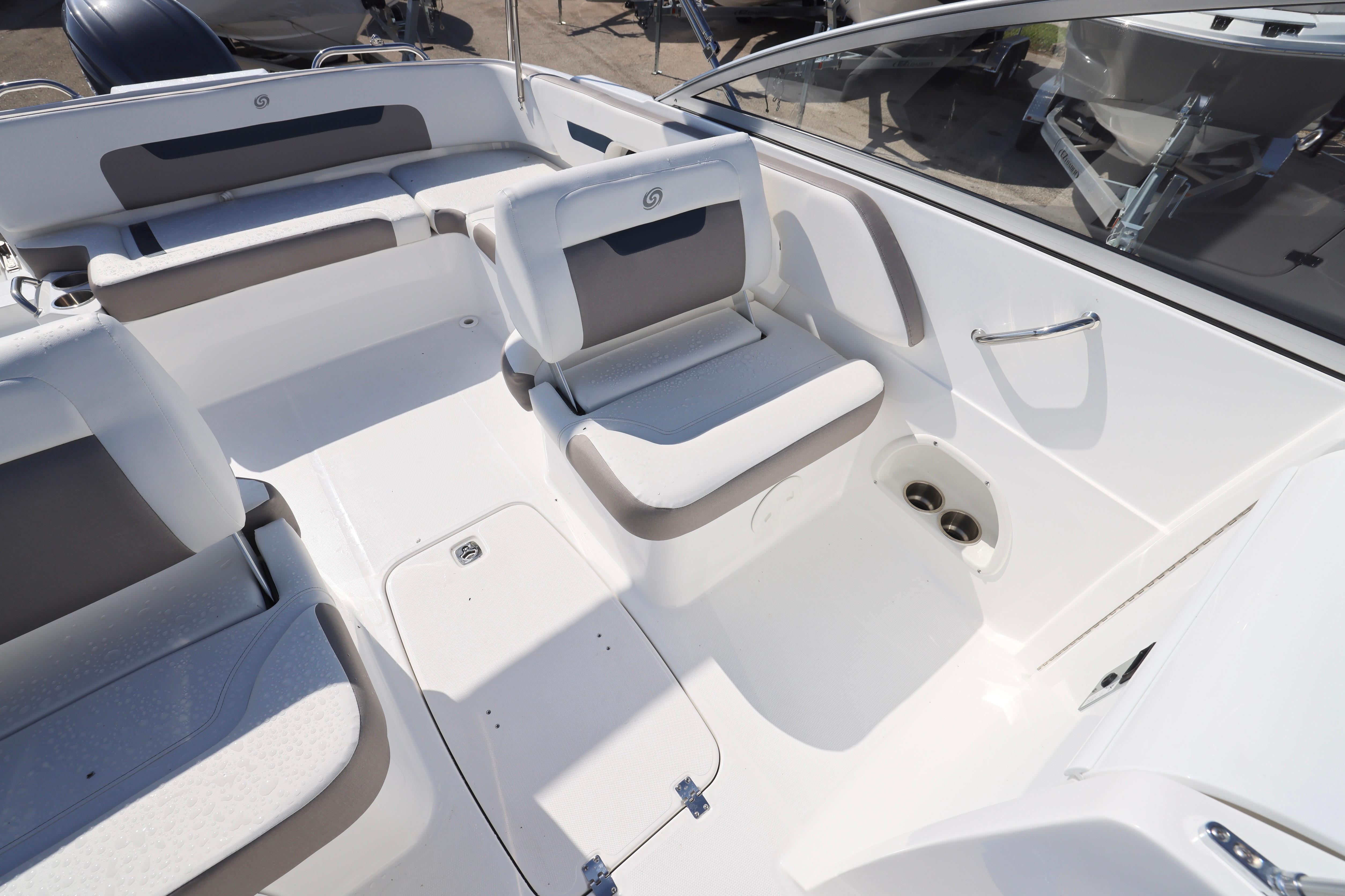 2026 Hurricane SunDeck 235 OB boat interior with white and gray seating arrangement.