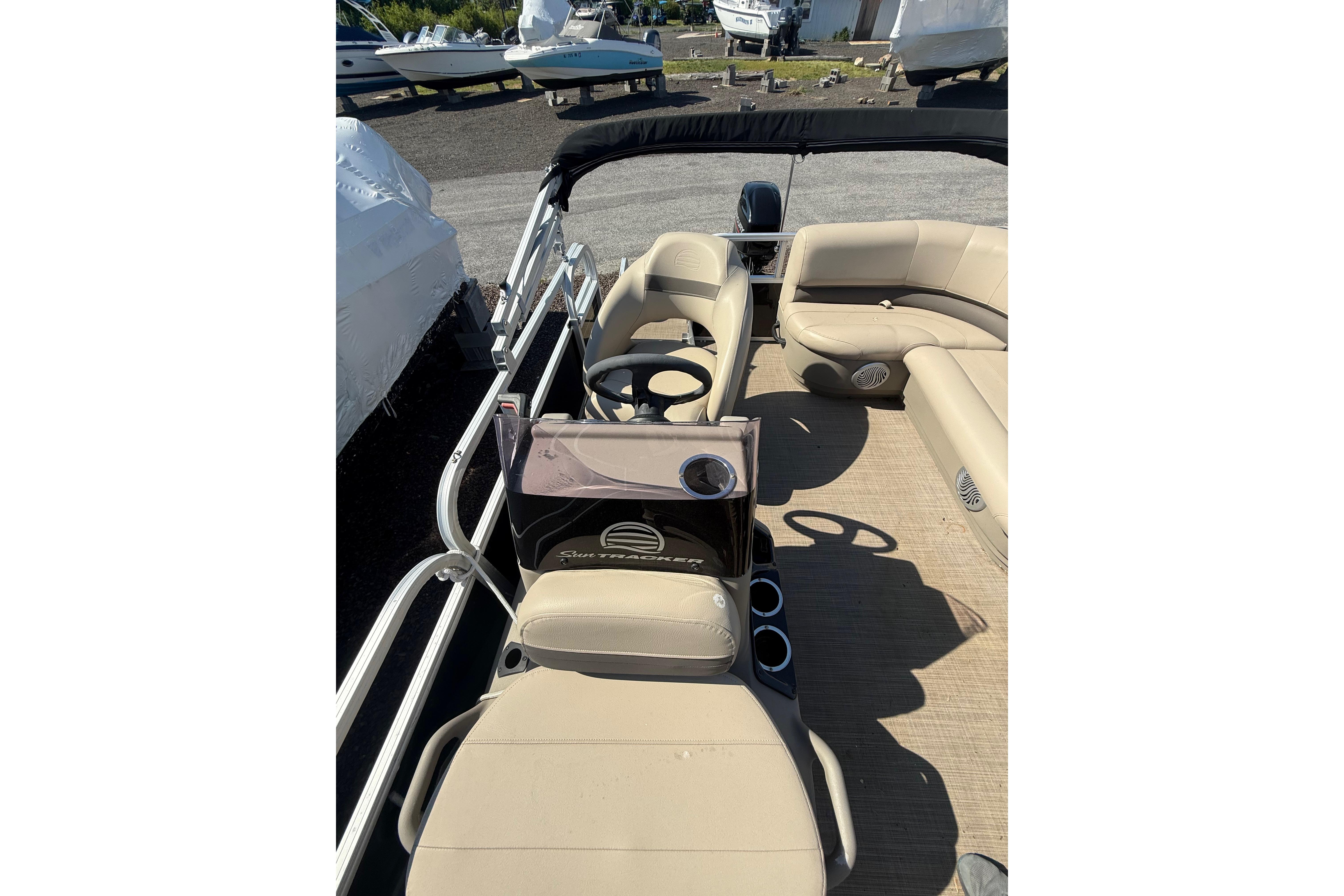 2021 Sun Tracker Bass Buggy 16 XL Select pontoon boat interior with beige seating.