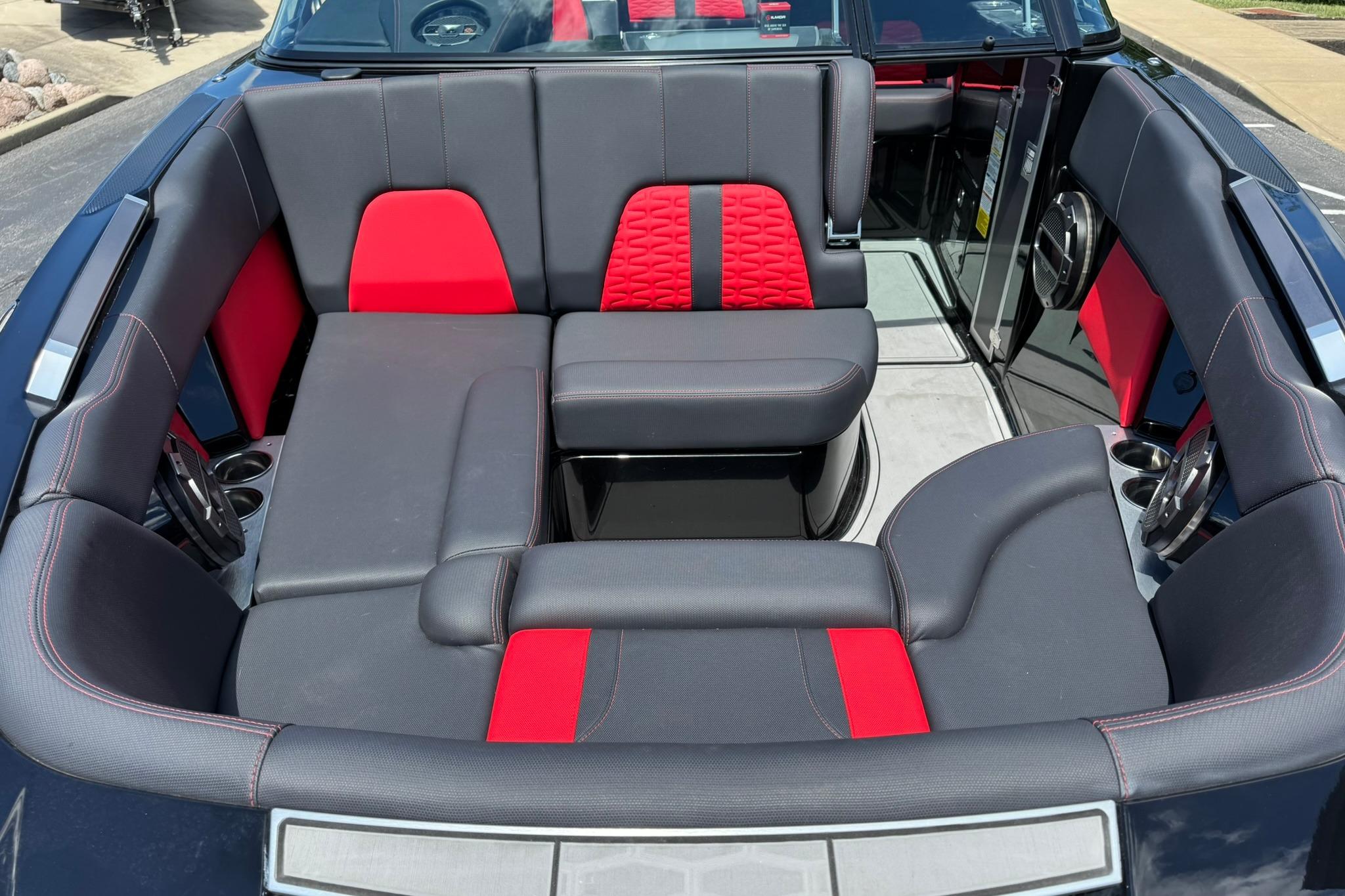 Interior of a 2021 MasterCraft X26 boat with red and black seating.