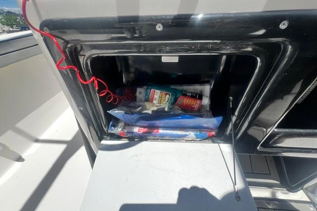 Storage compartment of 2019 Yamaha Boats 190 FSH Sport, containing various boating essentials.
