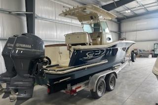 2015 Scout 255 LXF boat with Yamaha outboard motor in a storage facility.