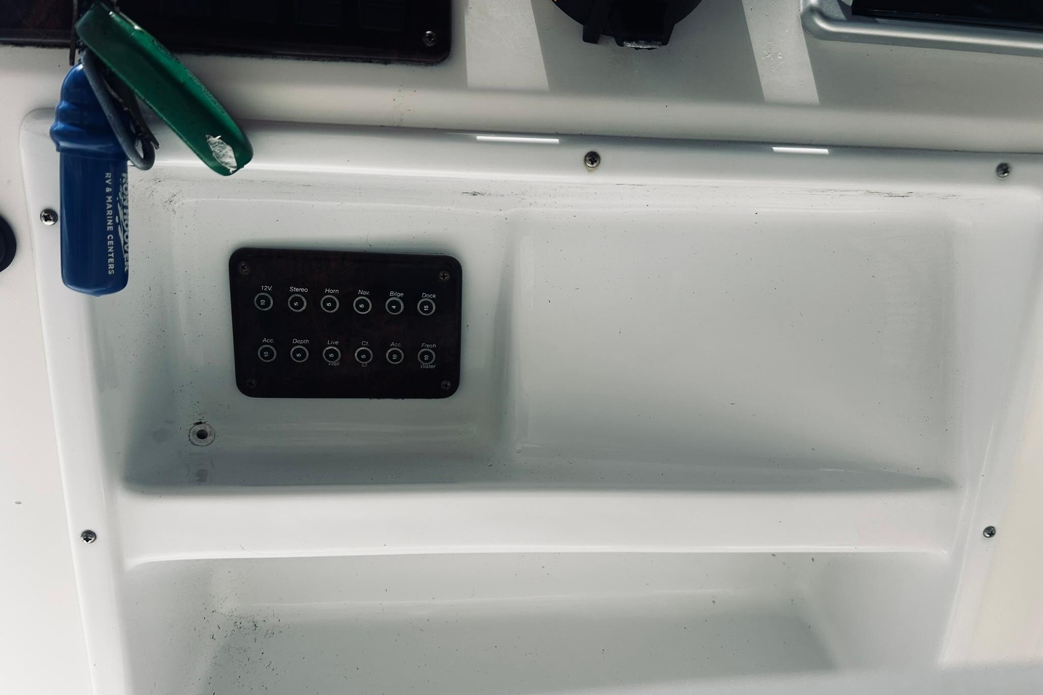 Control panel of a 2013 Hurricane SunDeck Sport 201 OB boat with labeled switches.