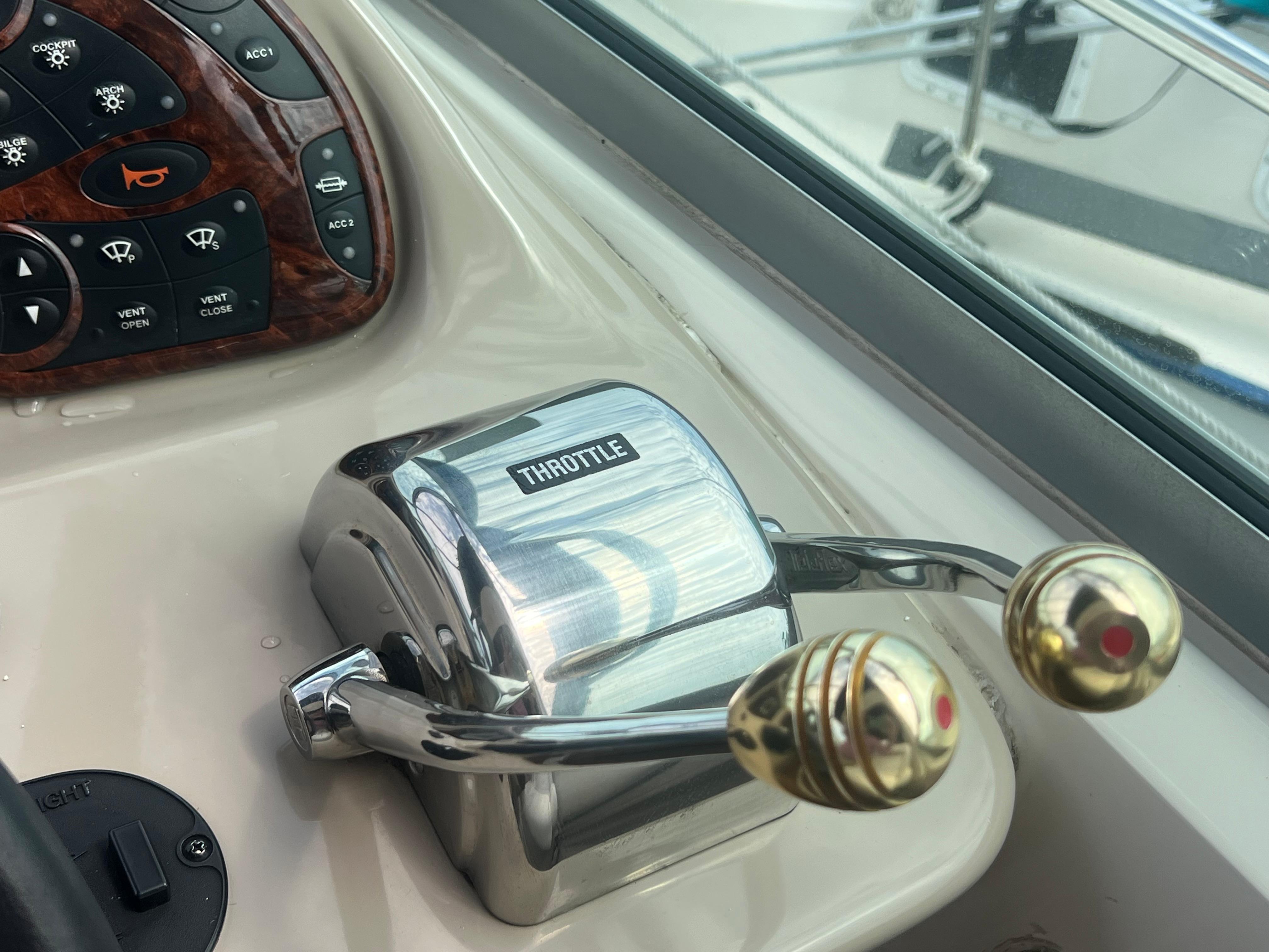 Throttle controls on a 2003 Sea Ray 320 Sundancer boat dashboard.