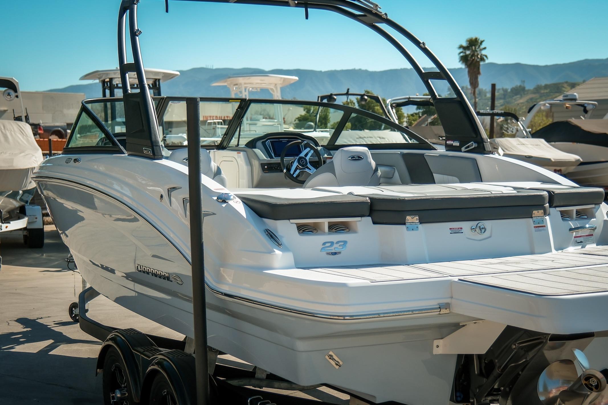 2026 Chaparral 23 SSi boat with sleek design, parked on a trailer.