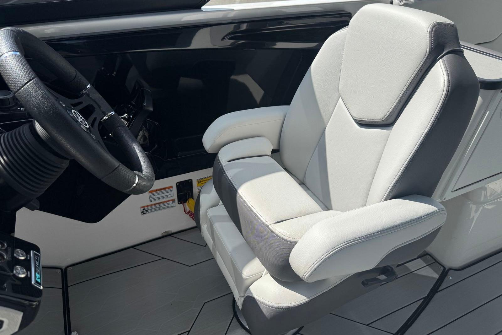 2023 Yamaha Boats 252XE cockpit with luxury seating and steering wheel.