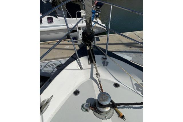 1982 Lancer 45 Motorsailer bow with winch and railing at dock.