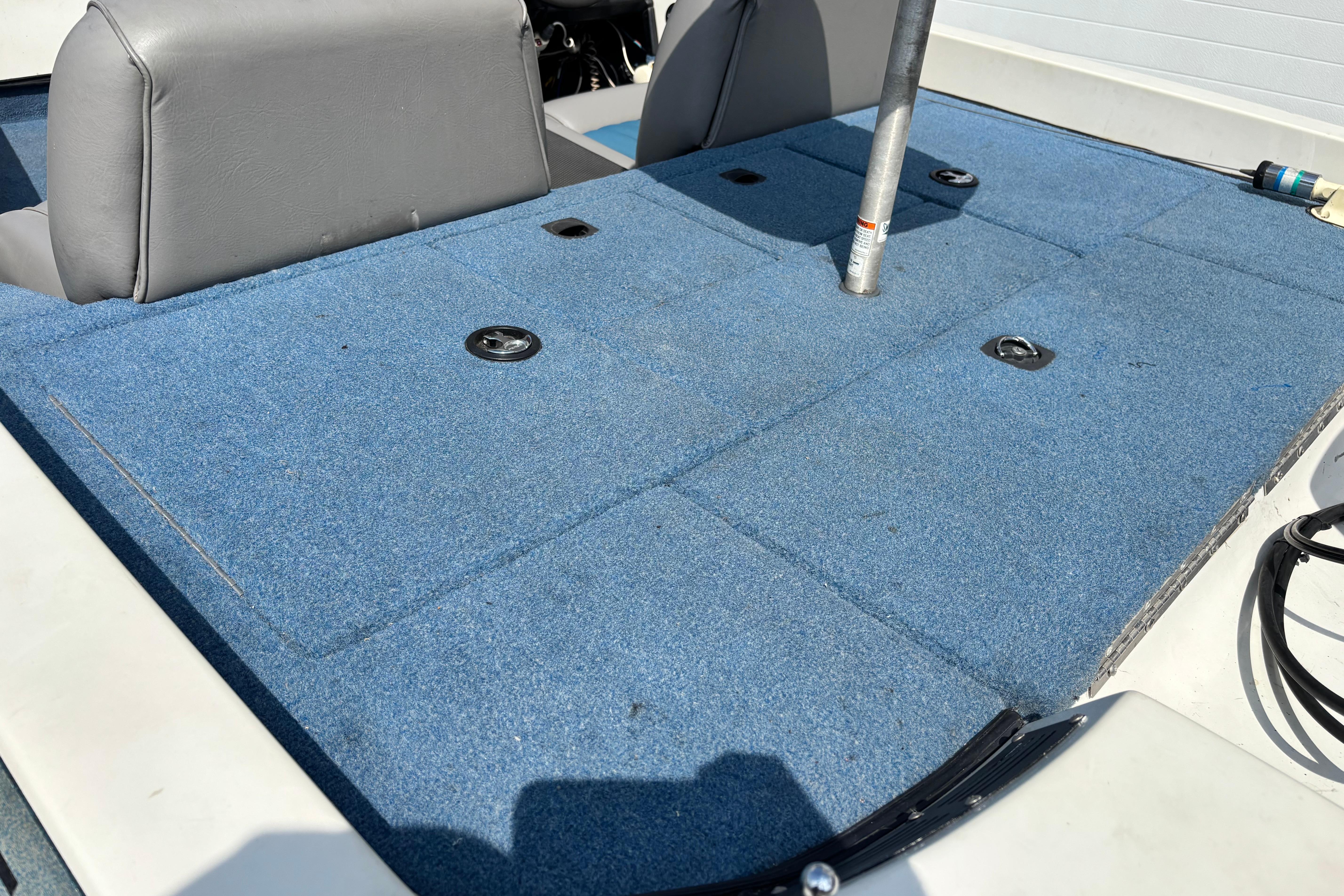 1991 Ranger 461VS boat interior with blue carpet and gray seats.