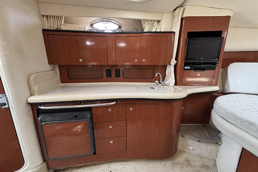Interior of 2002 Sea Ray Sundancer 320 yacht with kitchenette and seating area.