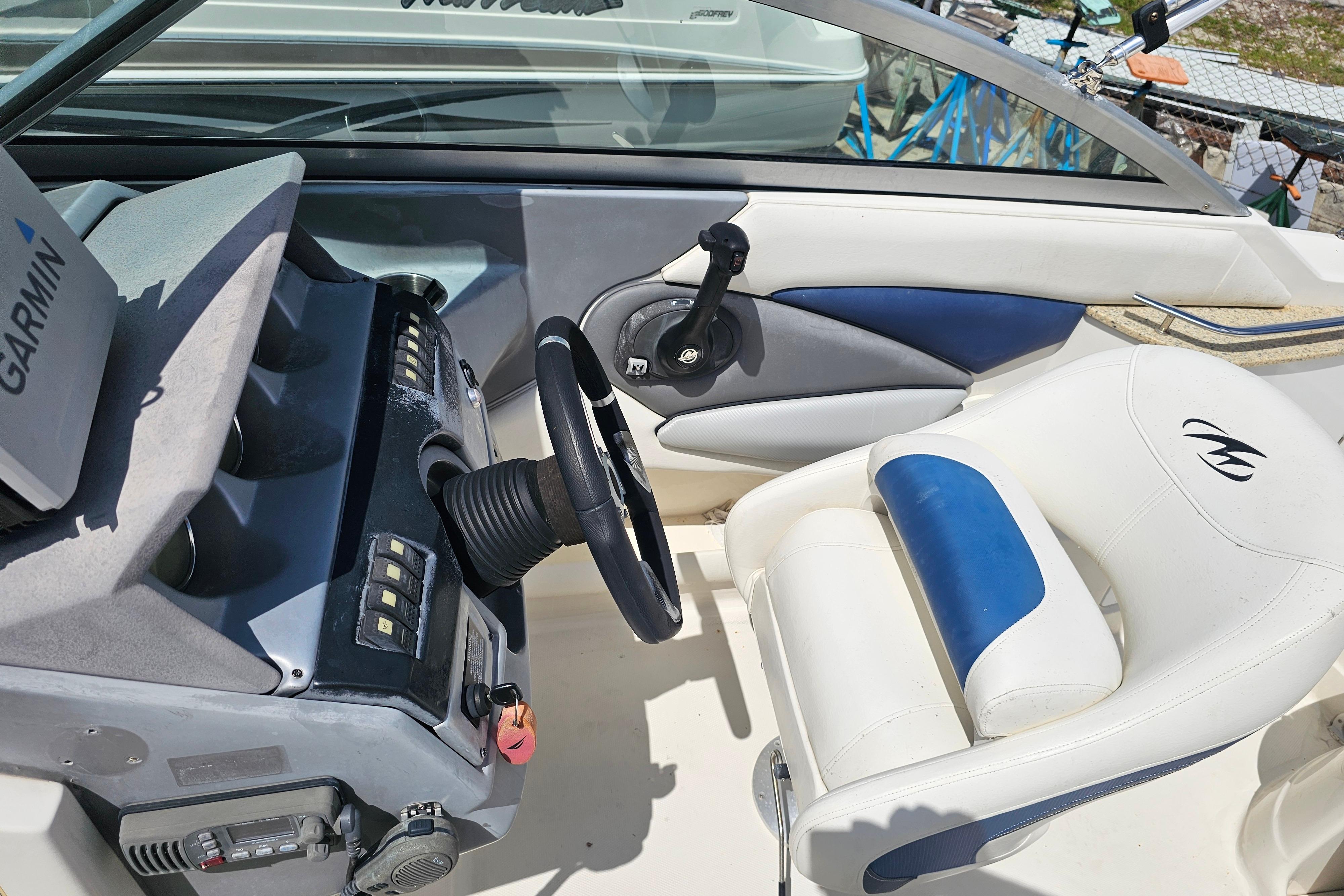 Interior of a 2008 Monterey 220 Explorer boat with steering wheel and Garmin device.