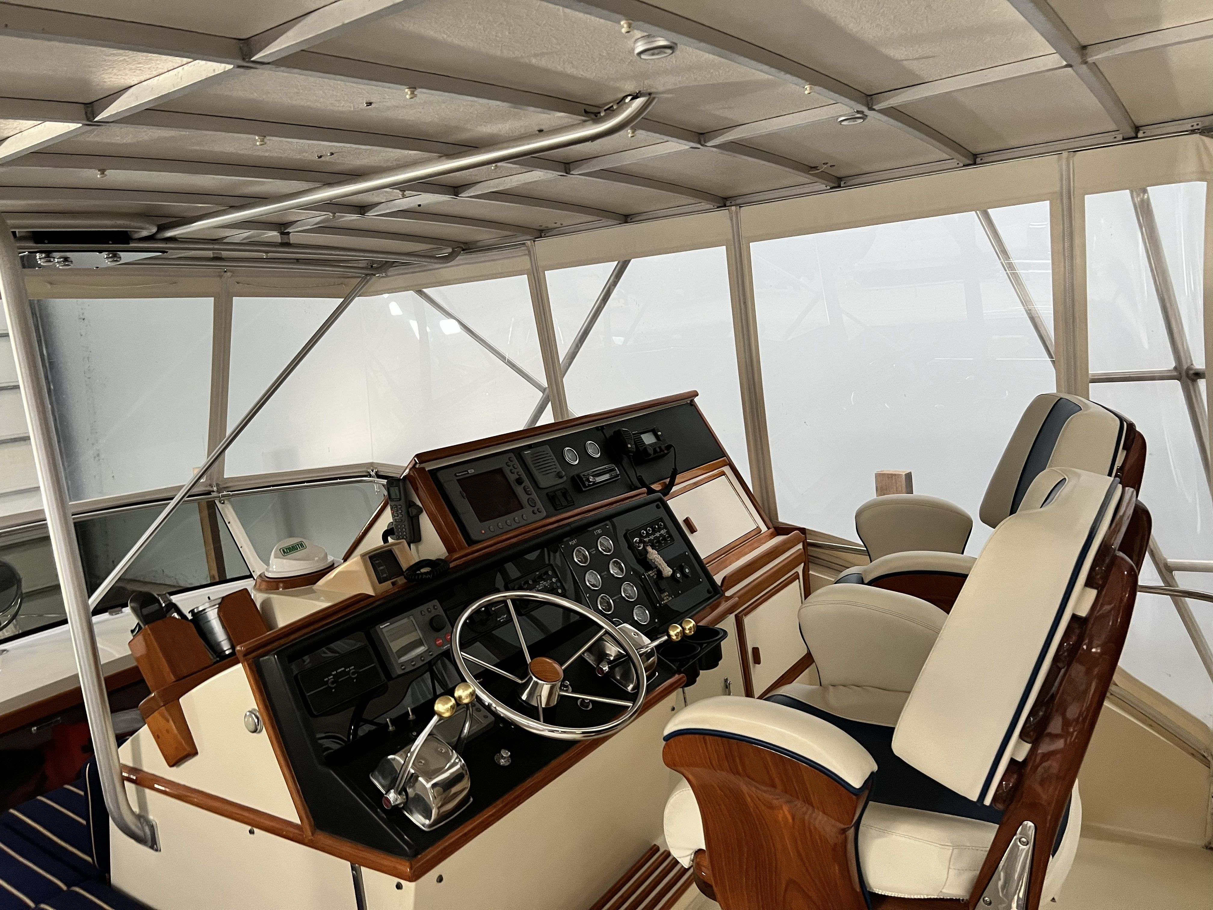 The cockpit of a 1979 Chris-Craft 45 TF with elegant seating and a classic helm station.
