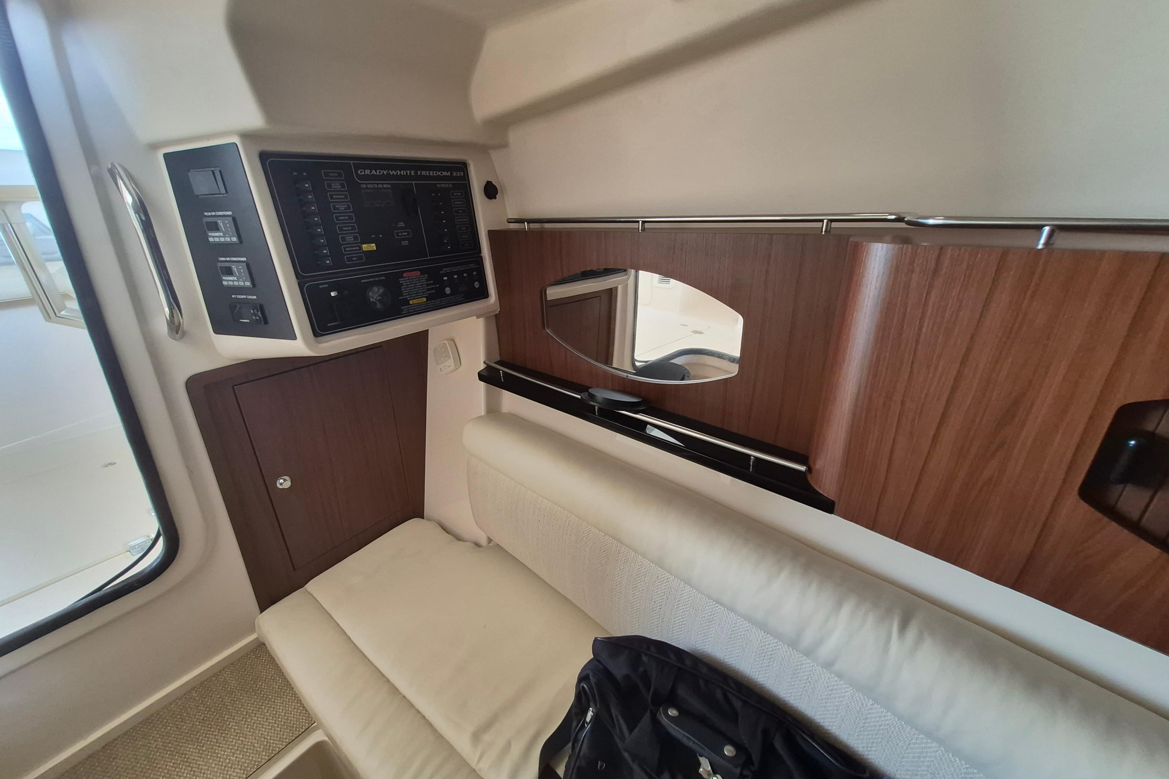 2019 Grady-White Freedom 335 cabin interior with control panel and seating area.