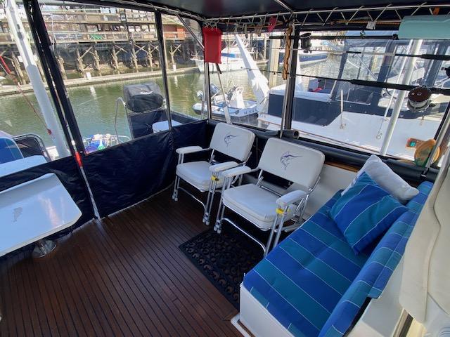 Interior of 1993 Grand Banks Classic yacht with seating and marina view.