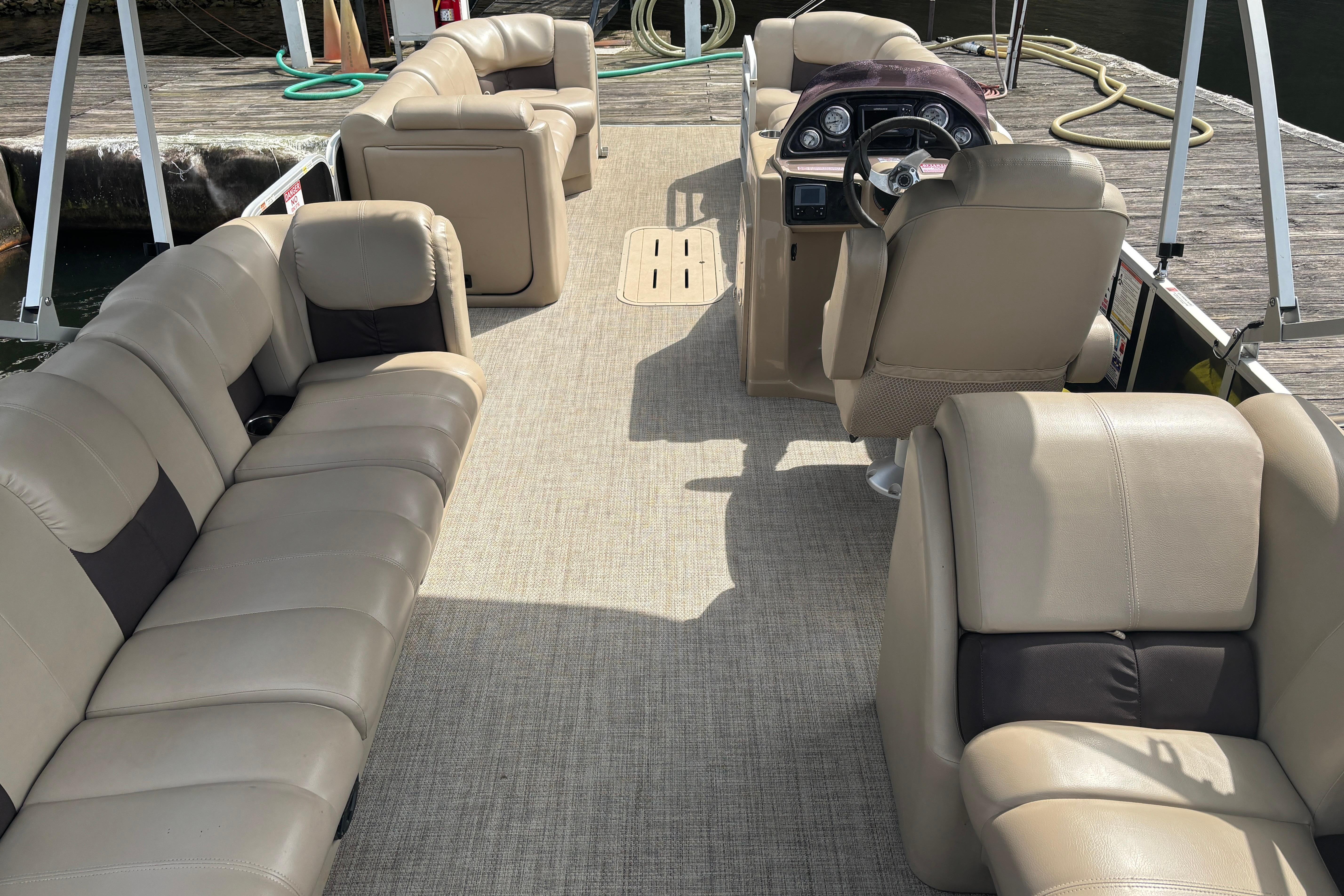 Luxurious interior of 2021 SunCatcher Fusion 325RCX pontoon boat with plush seating.
