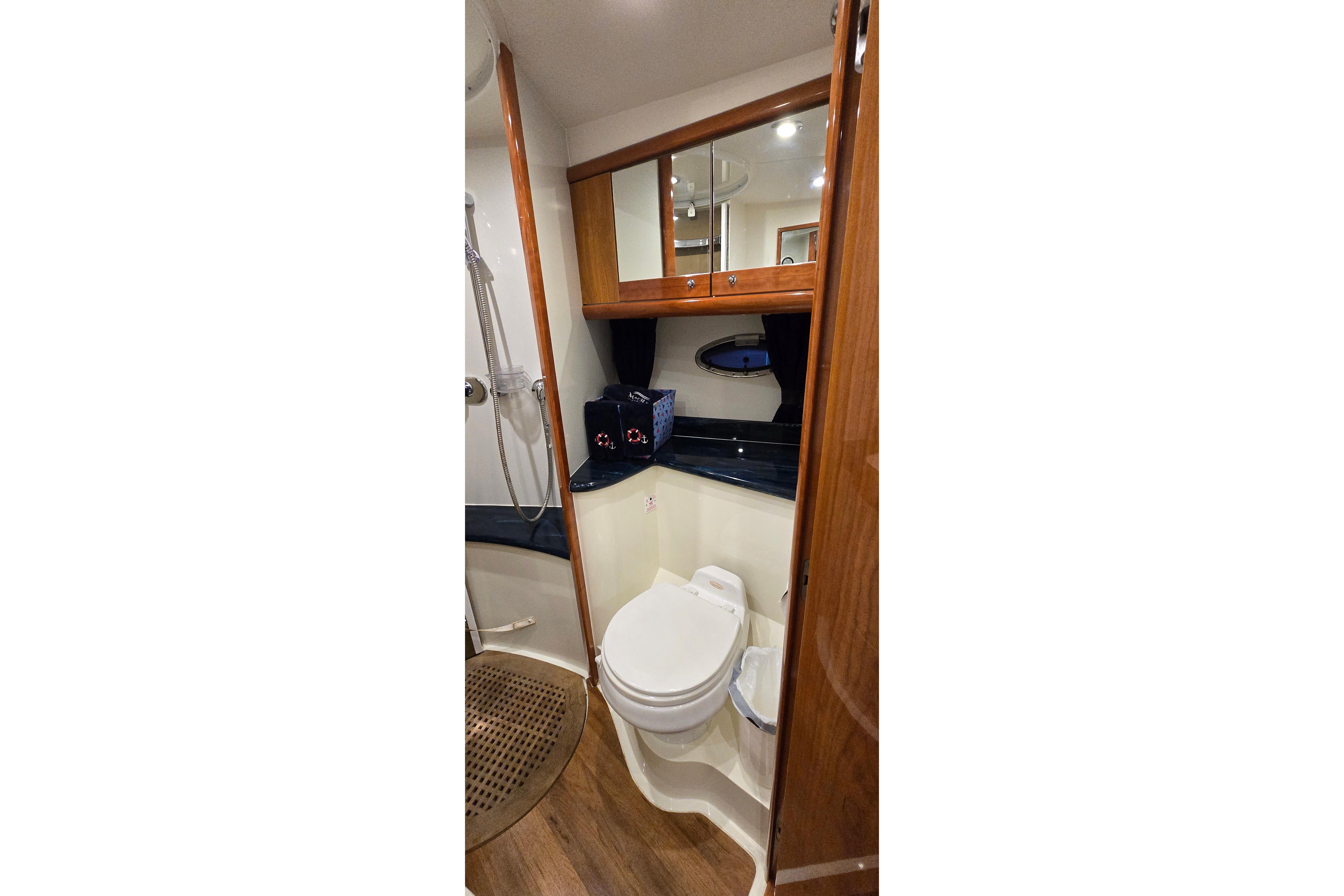 Luxurious bathroom in 2004 Sunseeker Camargue 50 yacht with wood accents and modern fixtures.