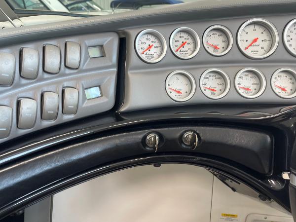 Dashboard of a 2005 Cobalt 343 boat with gauges and switches.