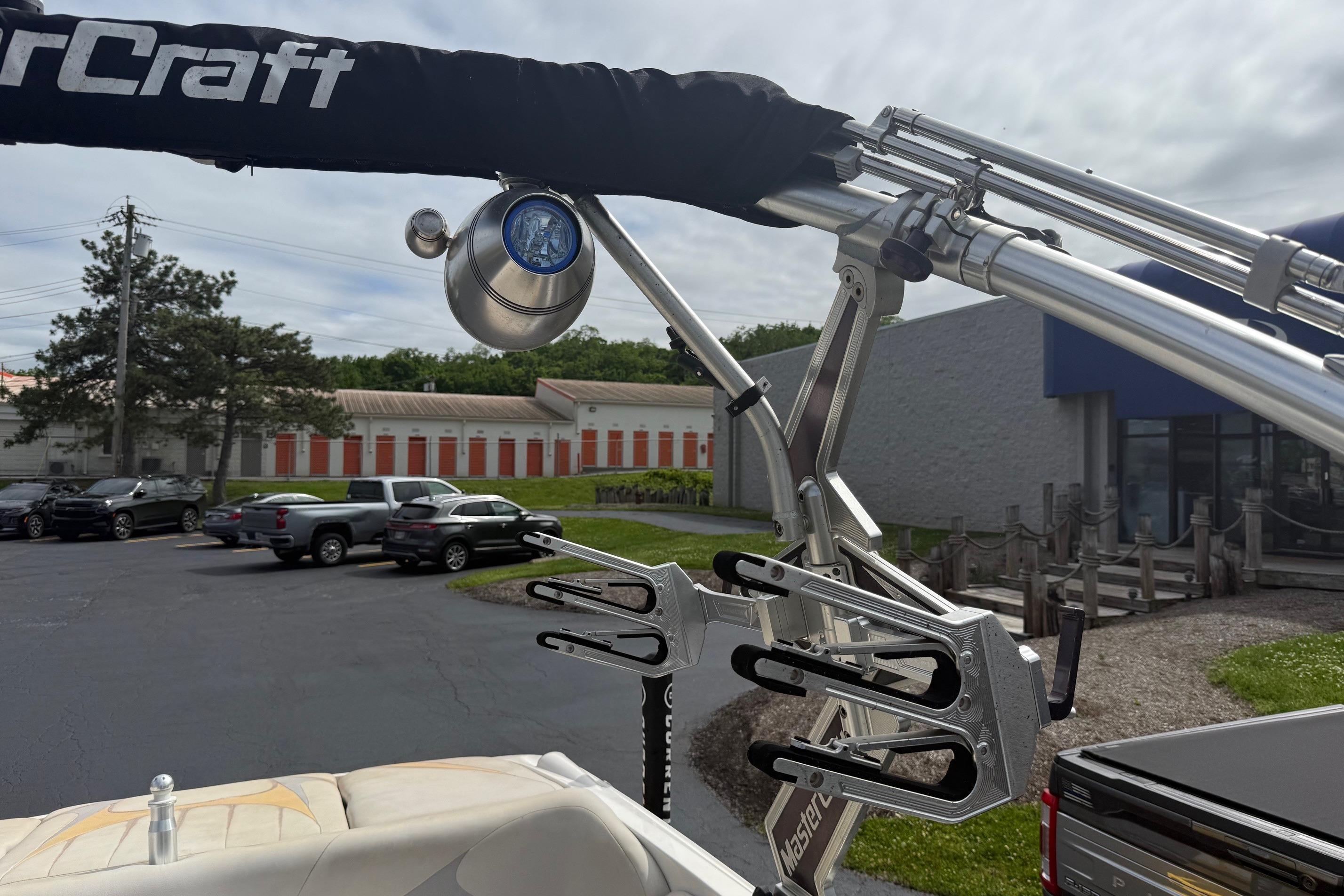 2008 MasterCraft X-15 boat tower with wakeboard rack in a parking lot setting.