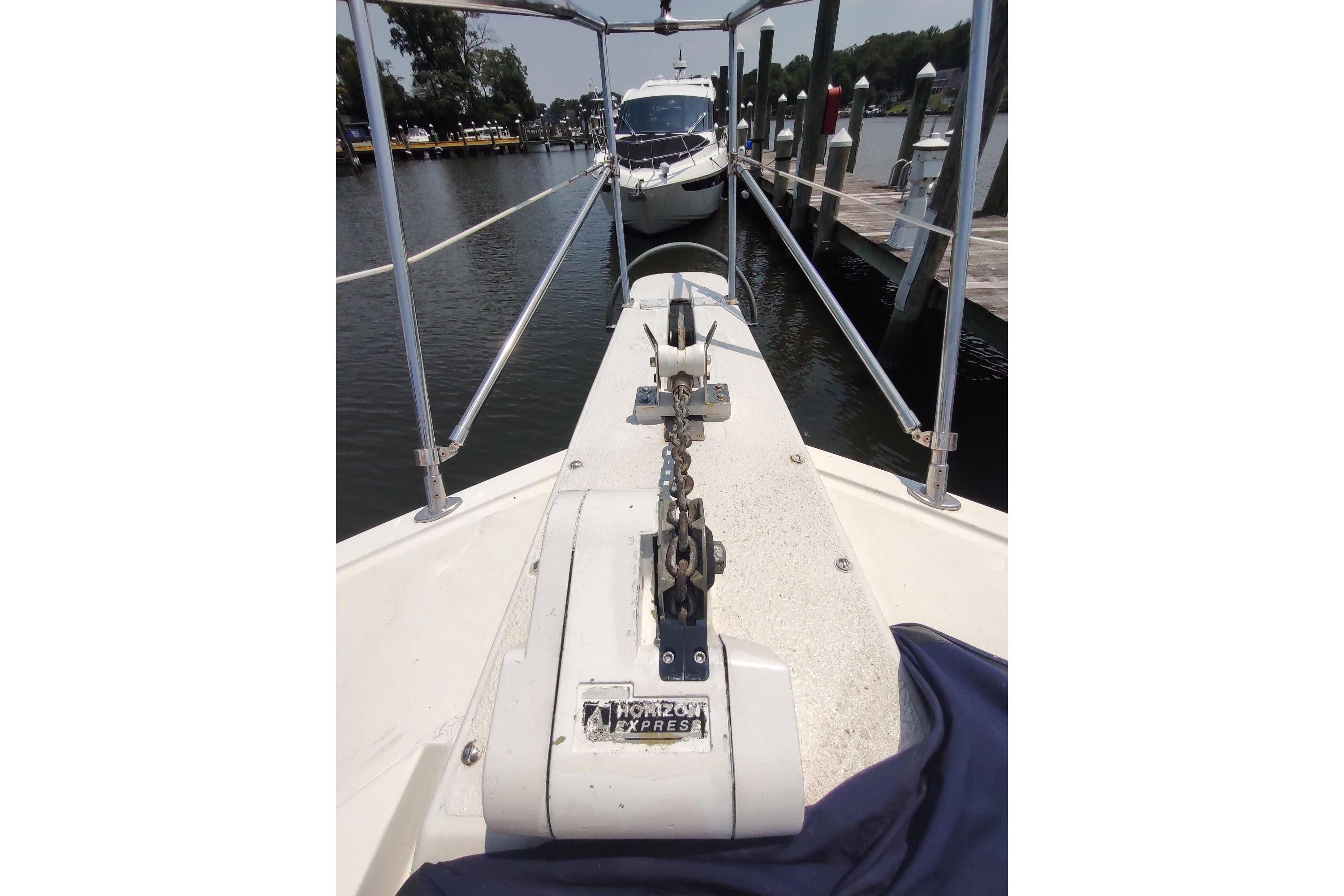 1989 Hyatt Double Cabin Motoryacht docked, showcasing bow and anchor chain.
