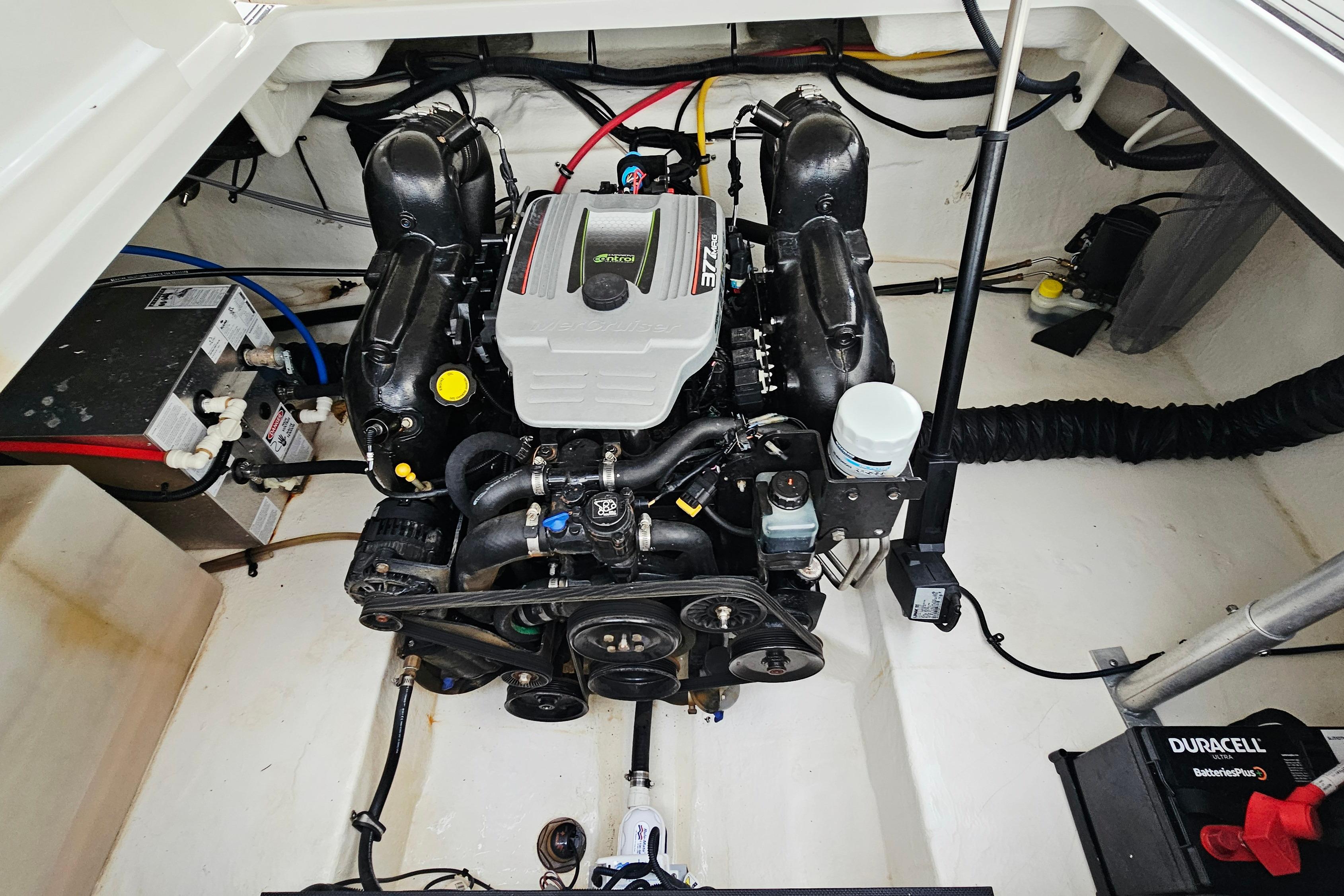 Engine compartment of a 2016 Monterey 295 Sport Yacht, featuring a clean and organized layout.
