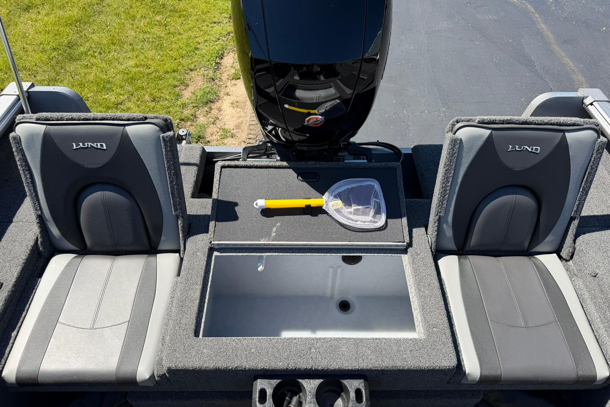 2024 Lund 1875 Impact XS Sport boat interior with seats and fishing net.