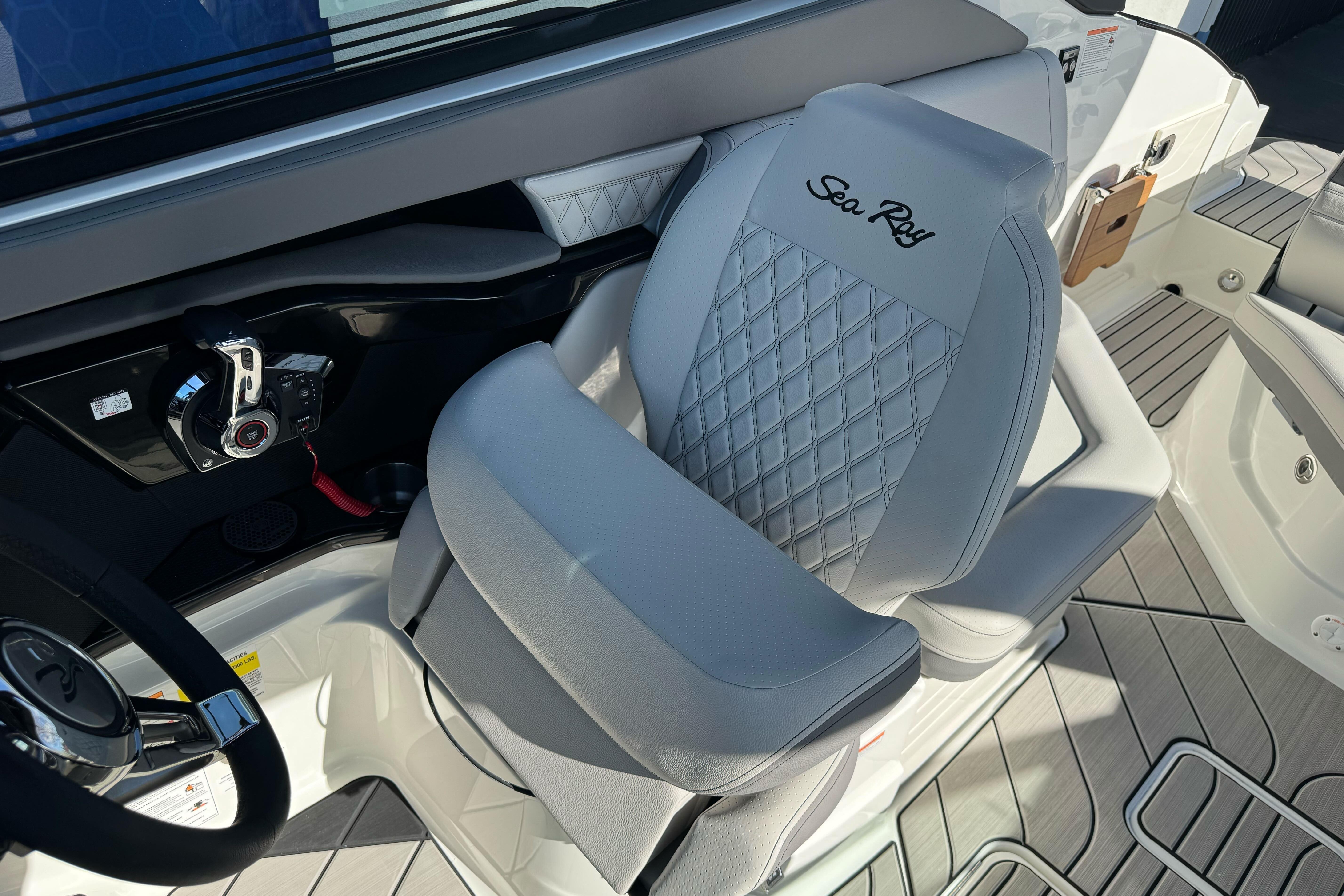 Luxury helm seat on 2026 Sea Ray SLX 260 boat, featuring elegant design and controls.