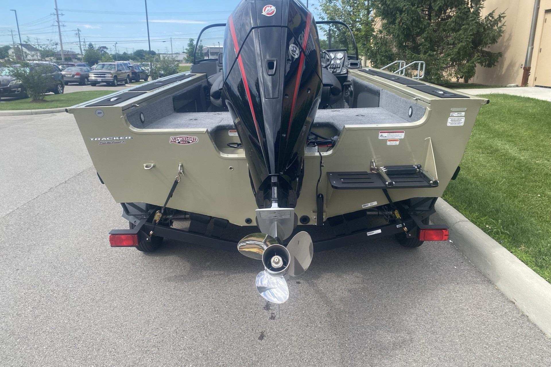 2026 Tracker Targa V-19 WT boat with powerful outboard motor, parked on pavement.