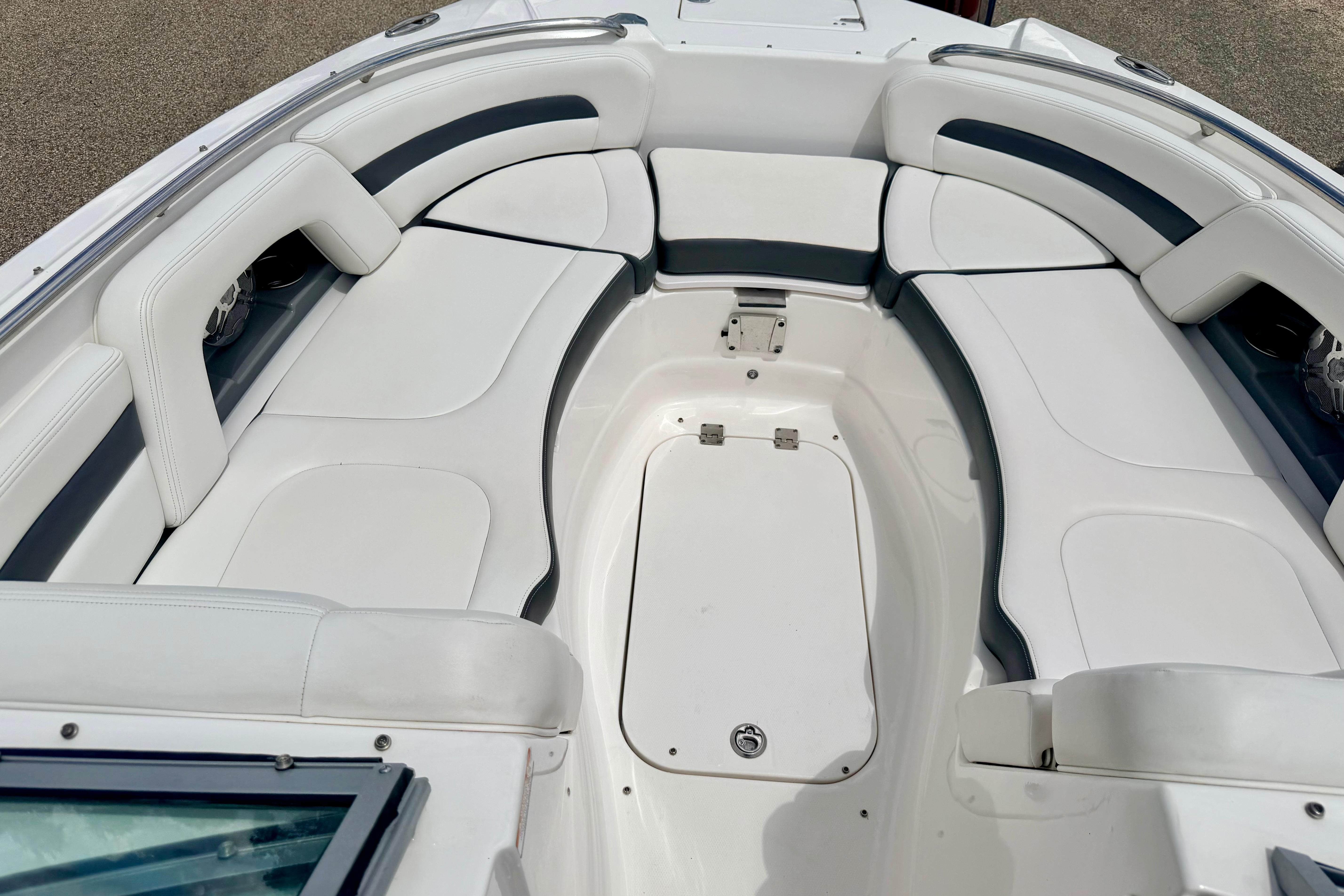 2015 Chaparral Sunesta 264 boat interior with white cushioned seating.