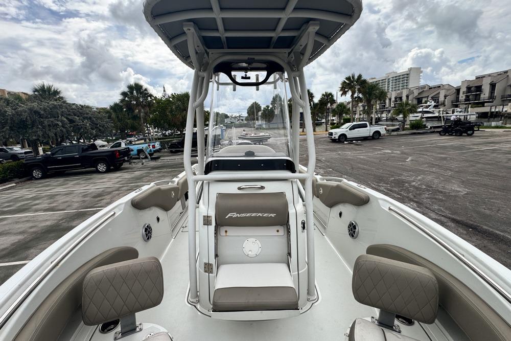 2023 Finseeker 220 CC boat at marina with cloudy sky backdrop.