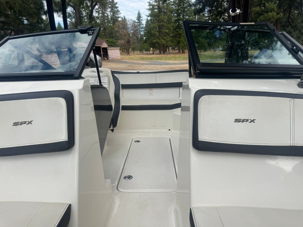 Interior view of a 2016 Sea Ray SPX 190 Outboard boat with open windshields.