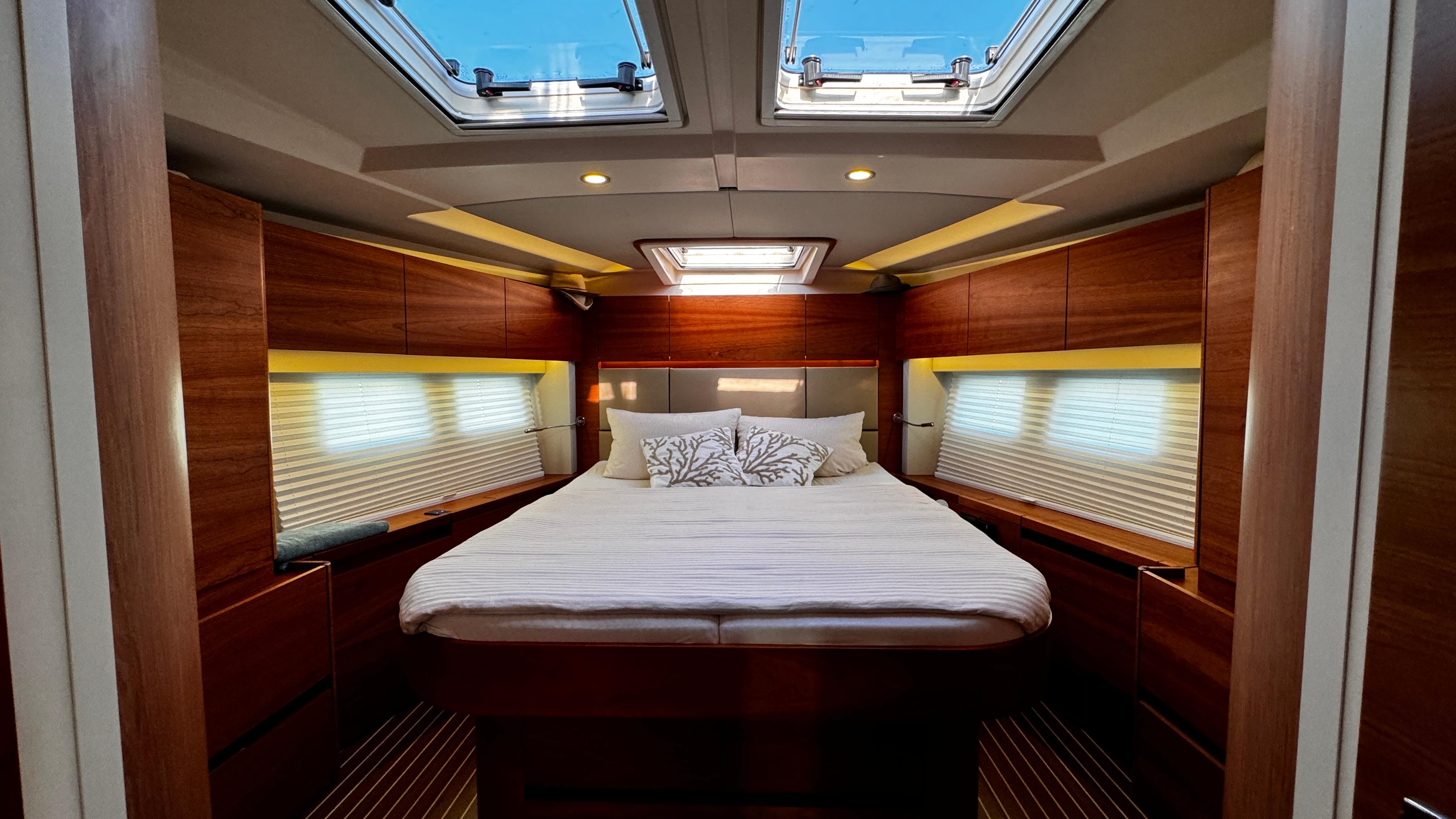 Luxurious 2020 Hanse 588 yacht cabin with skylights and elegant wood finish.