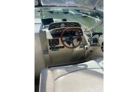 2000 Rinker Fiesta Vee 310 boat cockpit with steering wheel and control panel.
