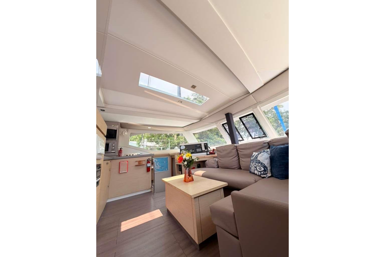Interior of 2018 Fountaine Pajot Lucia 40 catamaran, featuring modern seating and bright decor.