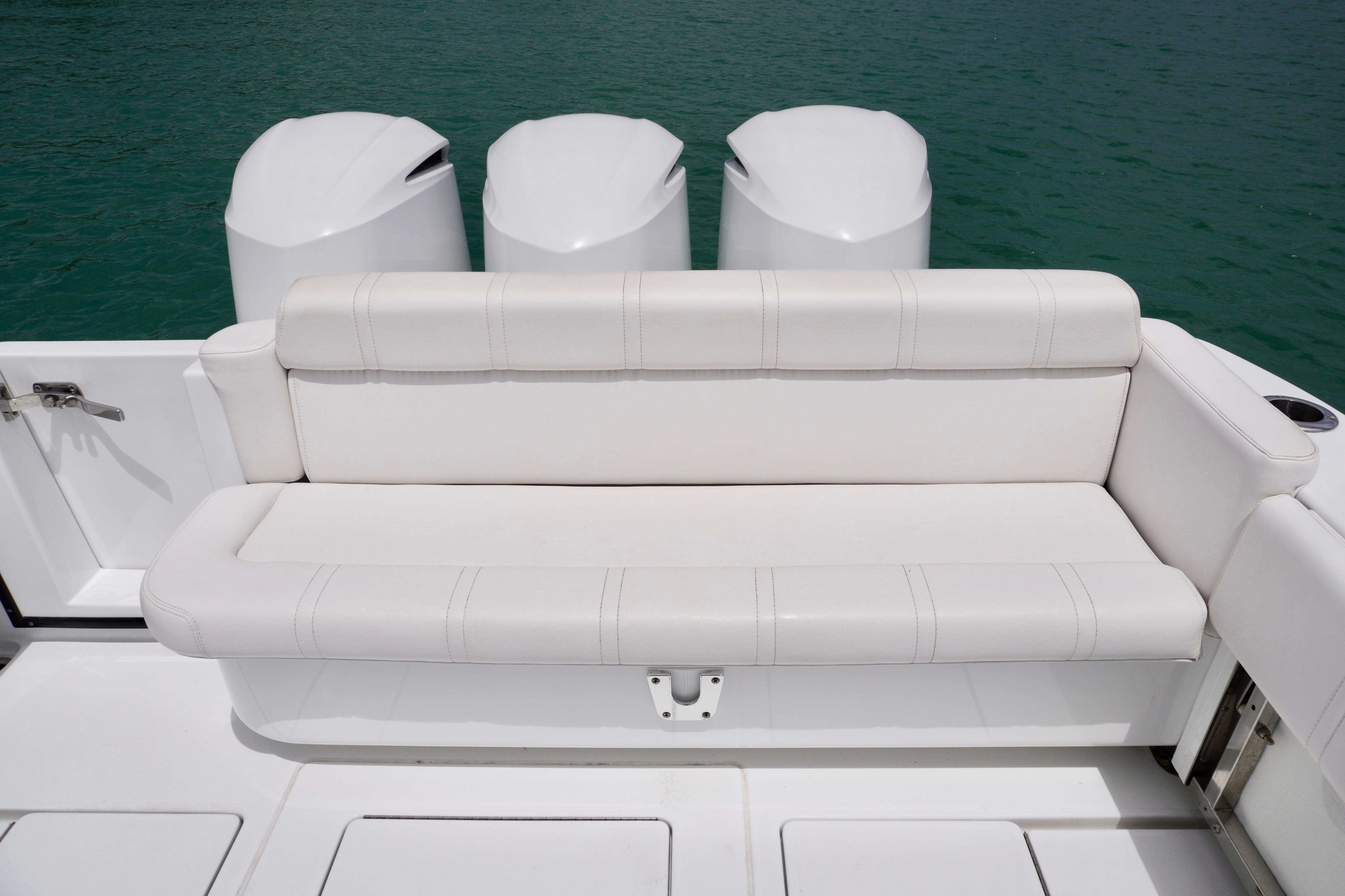 Contender 35 LS 2013 boat with white seating and triple outboard motors.