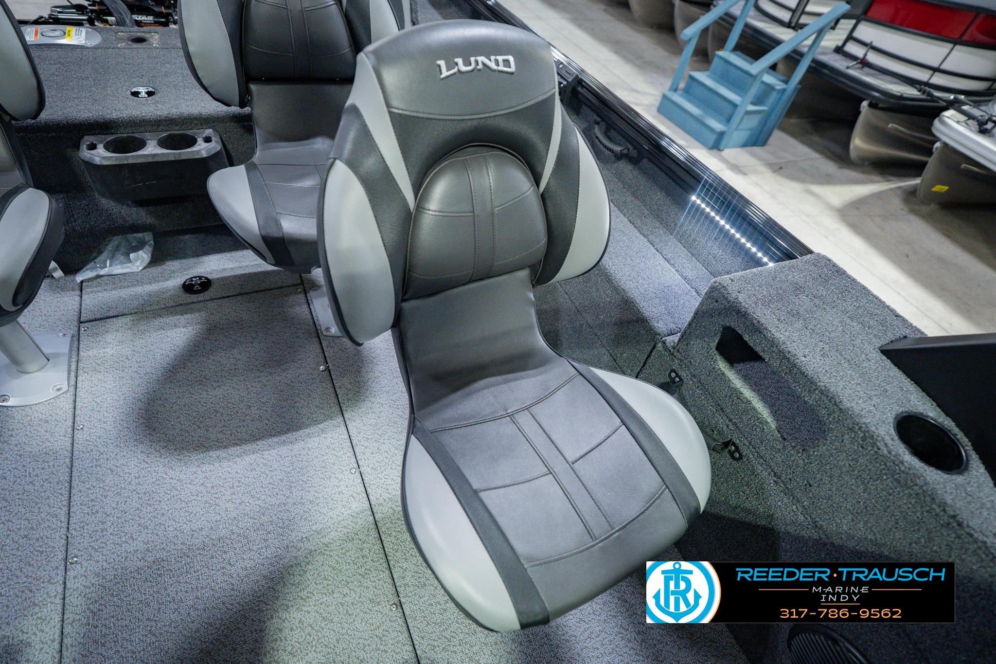 2026 Lund 1775 Impact XS boat interior with gray seating and carpeted flooring.